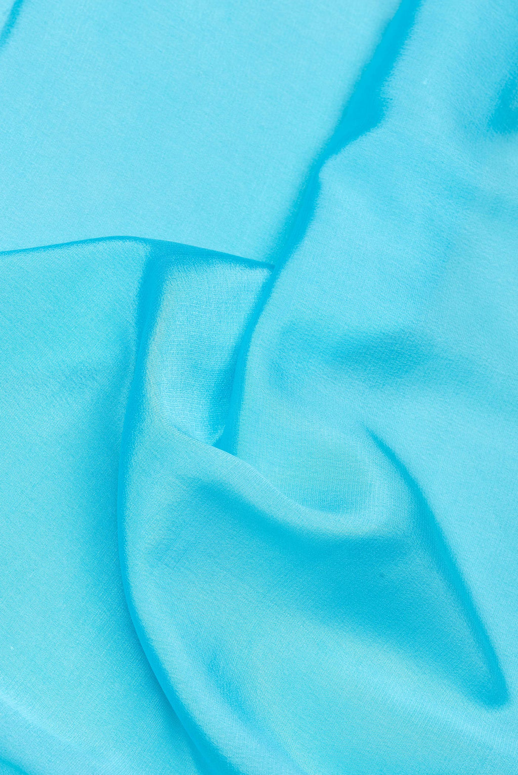 Close up of Sky Blue Mysore Silk Saree with Plain Body and Embroidery Border.  displaying folds