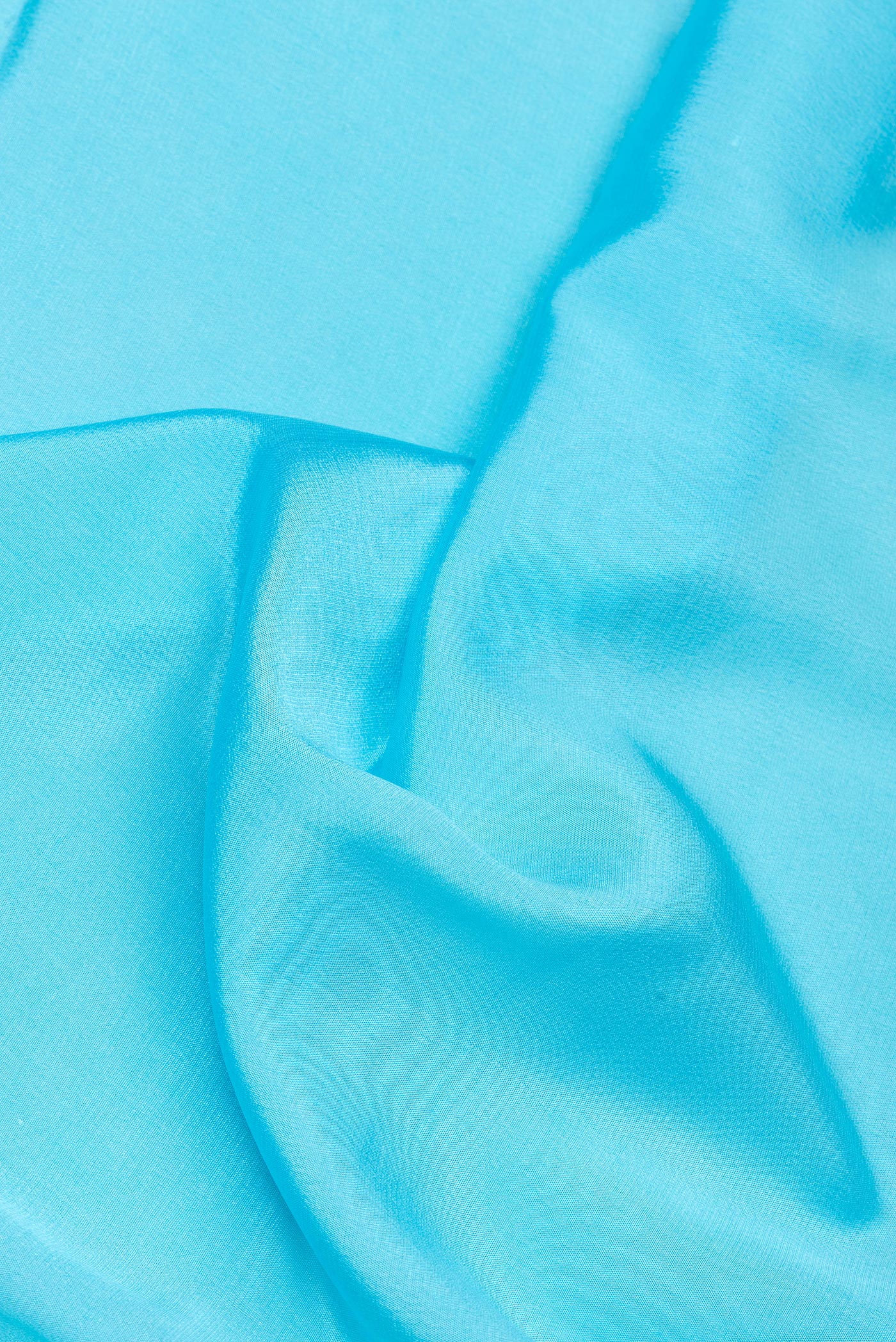 Close up of Sky Blue Mysore Silk Saree with Plain Body and Embroidery Border.  displaying folds