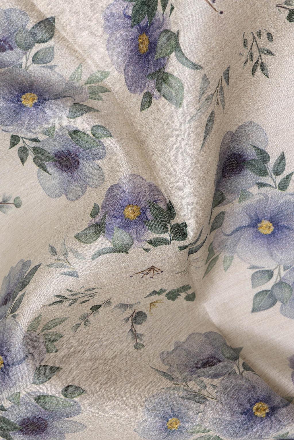 Close up of Beige Tussar Silk Saree with Floral Print on the body and Zari Border.  displaying folds
