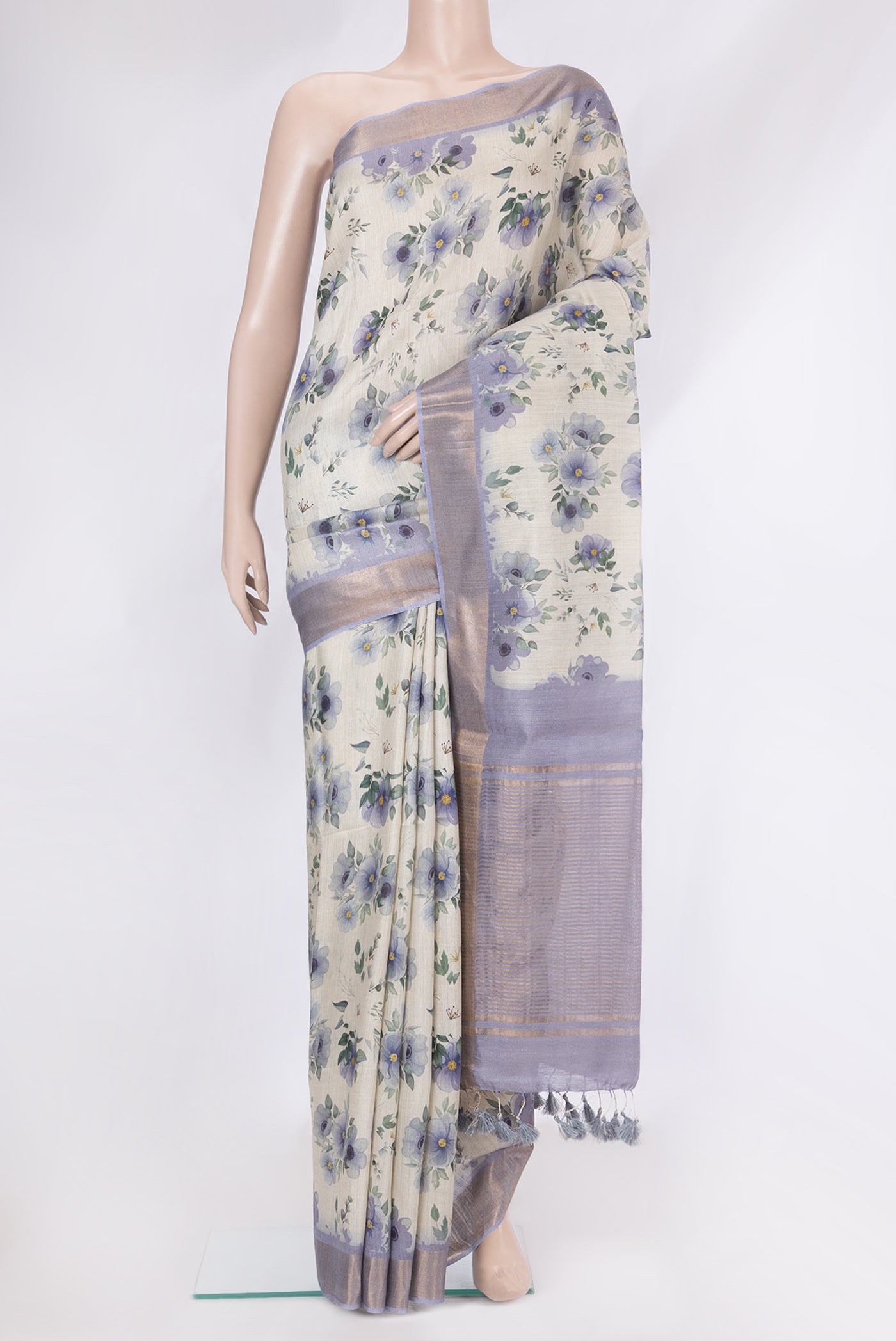 Beige Tussar Silk Saree with Floral Print on the body and Zari Border.  displayed on a mannequin