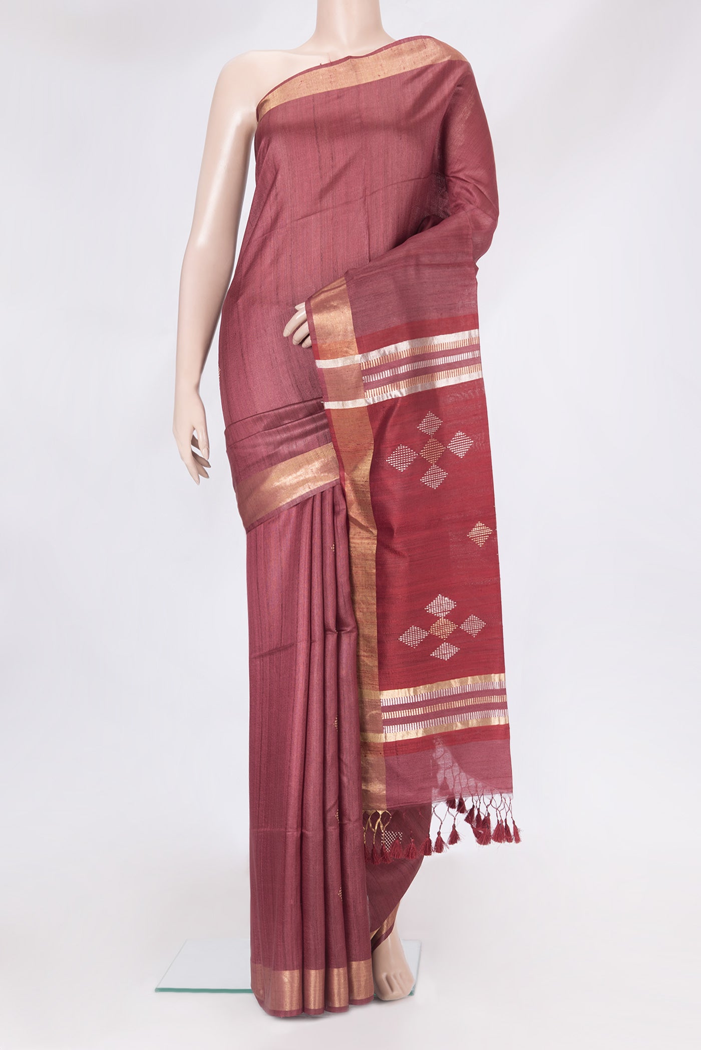 Maroon Tussar Silk Saree with Thread Butta on the body and Zari Border.  displayed on a mannequin