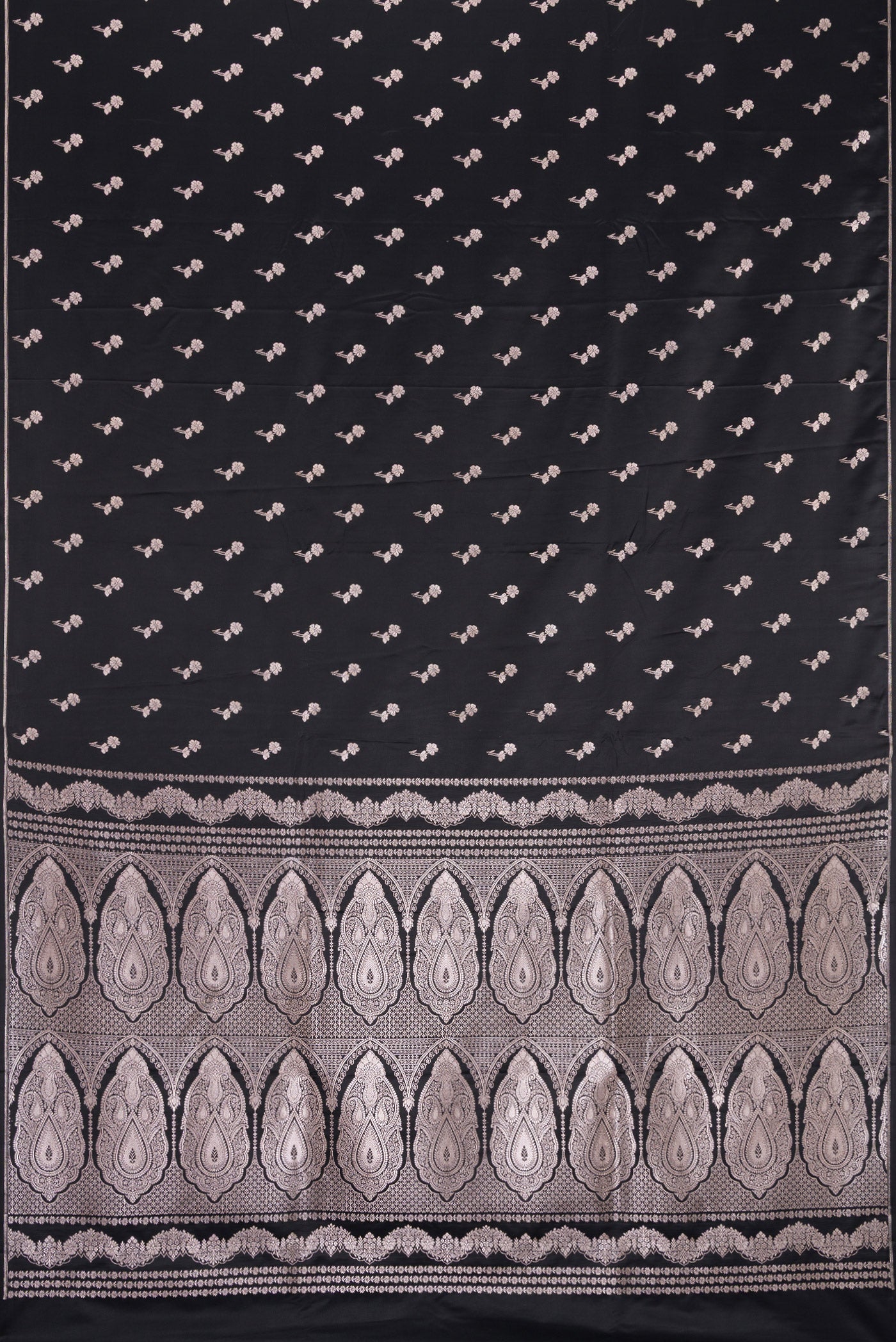 Flat view of Black Dual Tone Blended Banarasi Silk Saree with Zari Butta on the body and Thin Zari Line. 