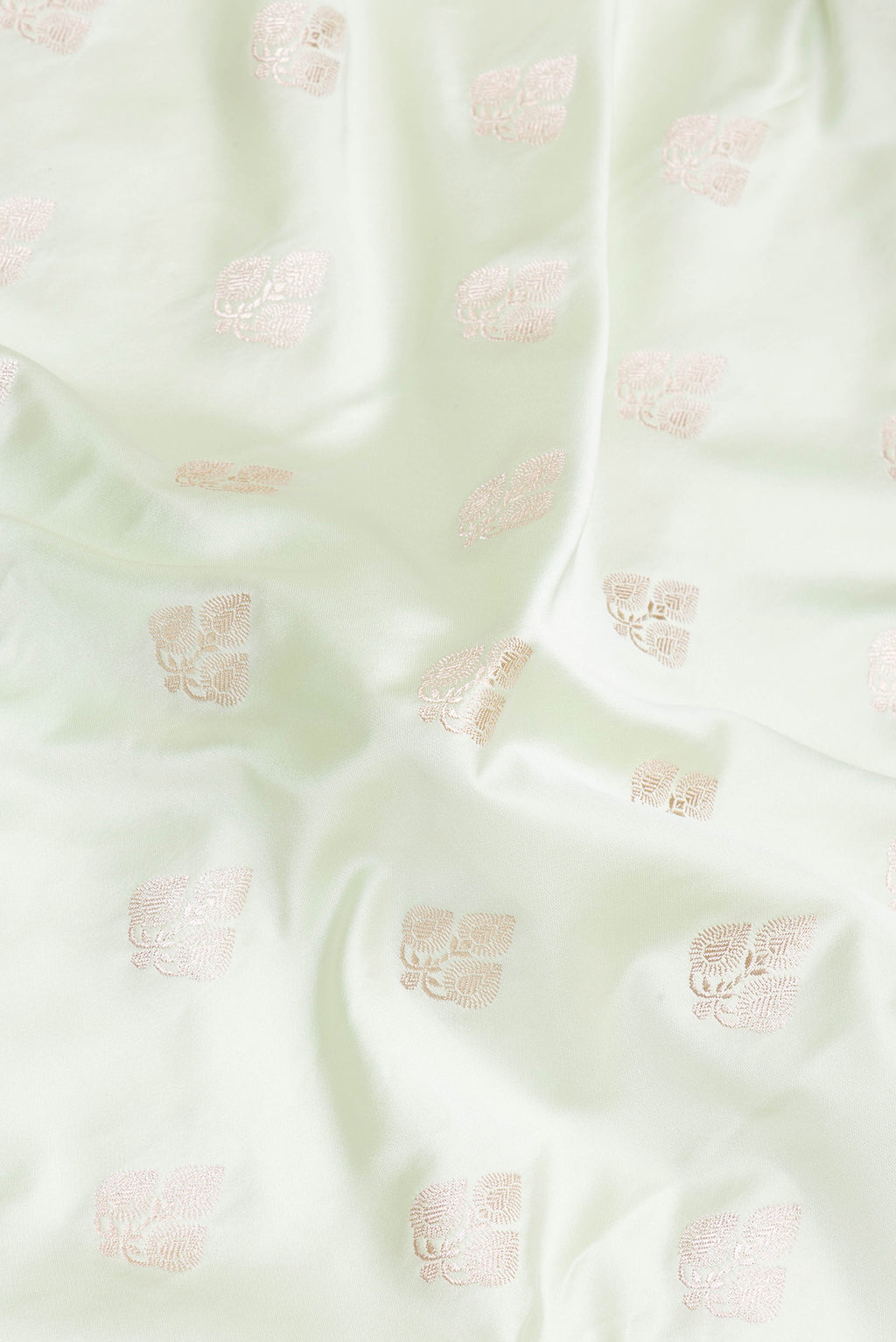Close up of Pista Green Blended Banarasi Silk Saree with Zari Butta on the body and Zari Border.  displaying folds