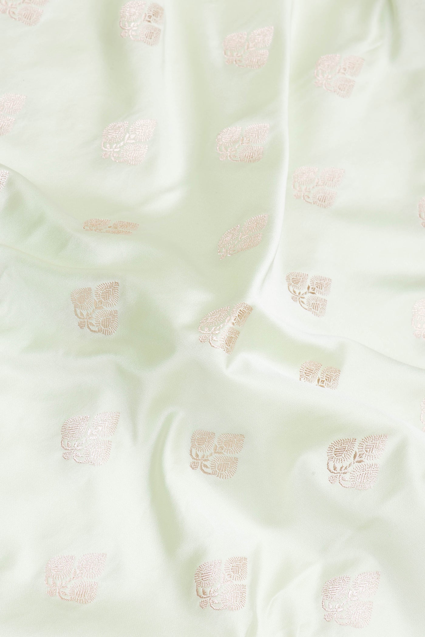 Close up of Pista Green Blended Banarasi Silk Saree with Zari Butta on the body and Zari Border.  displaying folds