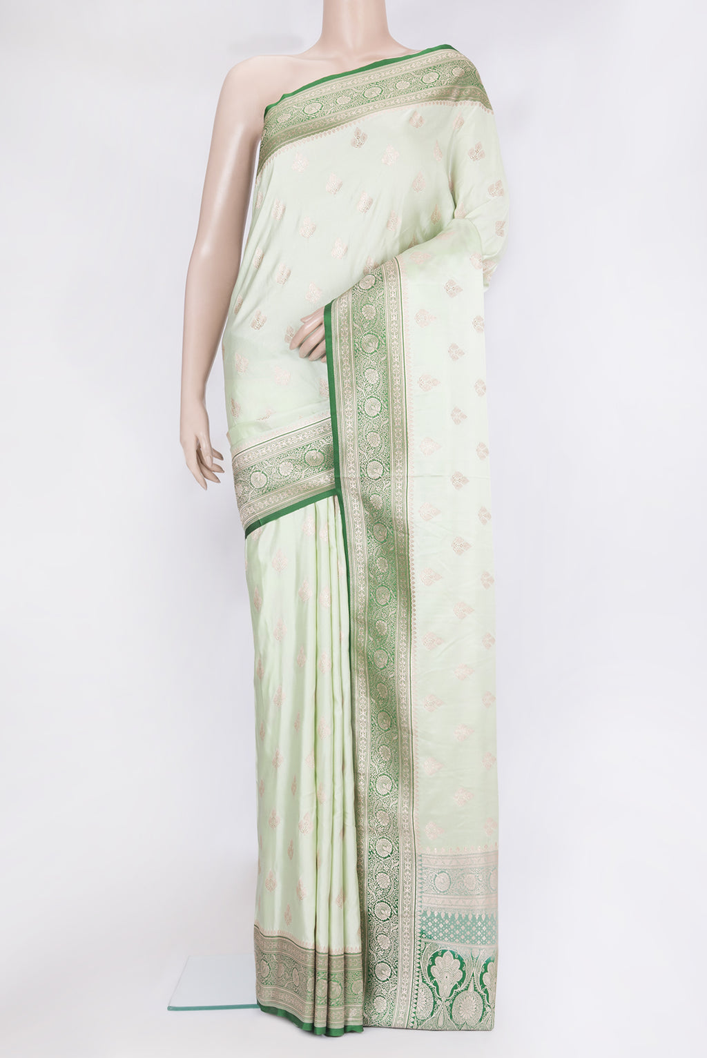 Pista Green Blended Banarasi Silk Saree with Zari Butta on the body and Zari Border.  displayed on a mannequin