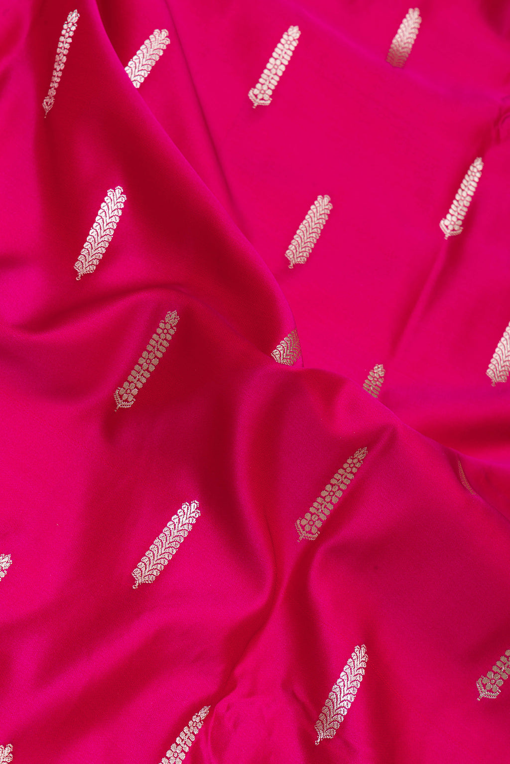 Close up of Dark Pink Blended Banarasi Silk Saree with Zari Butta on the body and Zari Border.  displaying folds