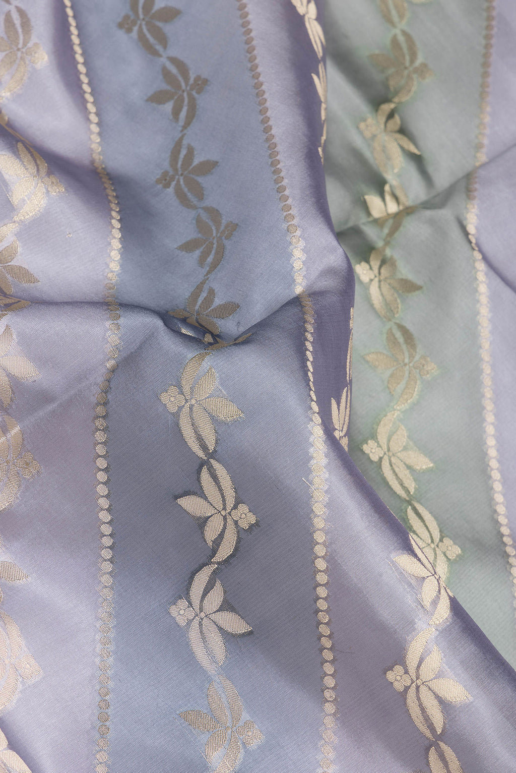 Close up of Grey Dual Tone Tussar Silk Saree with Zari Brocade on the body and Zari Border.  displaying folds