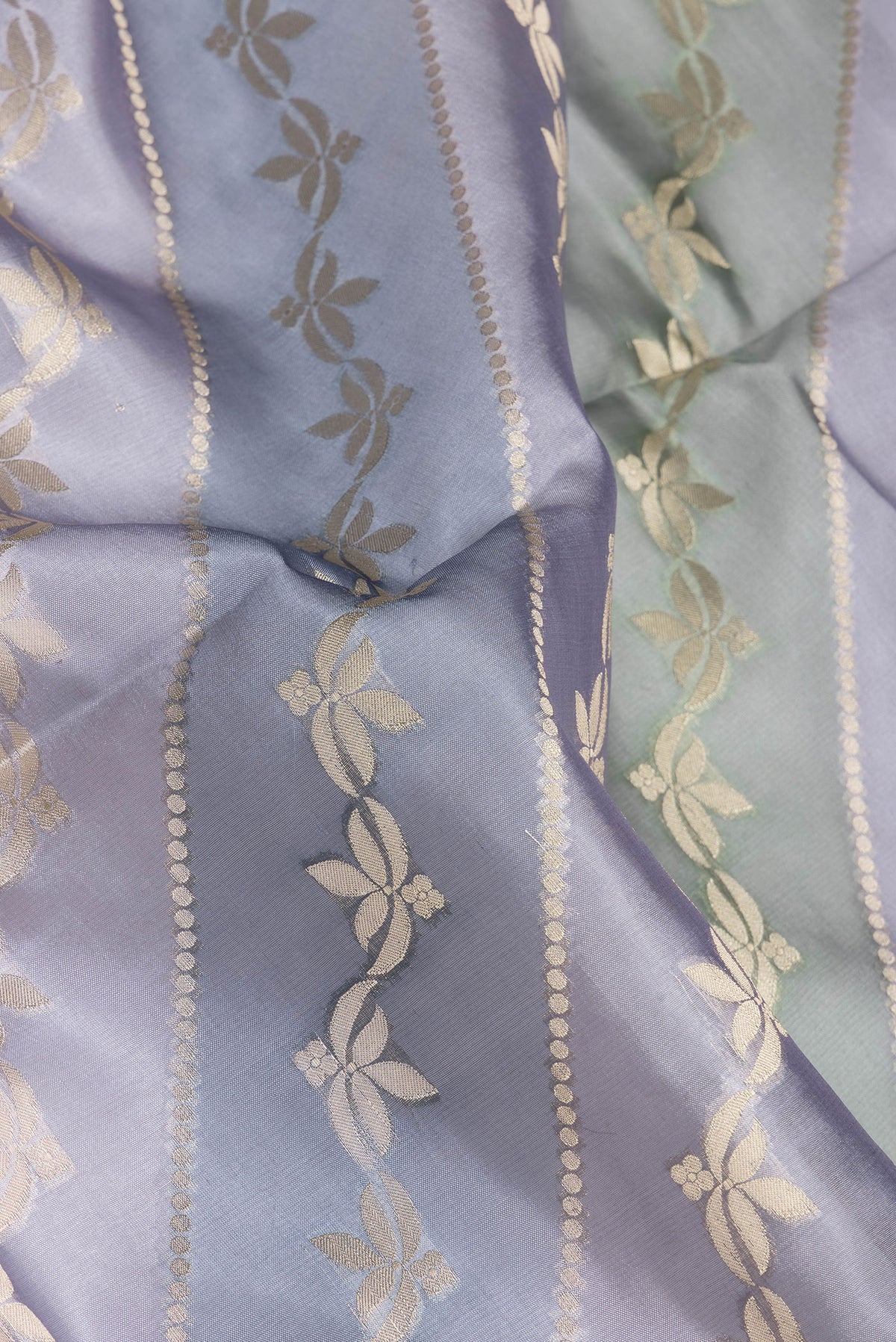Close up of Grey Dual Tone Tussar Silk Saree with Zari Brocade on the body and Zari Border.  displaying folds