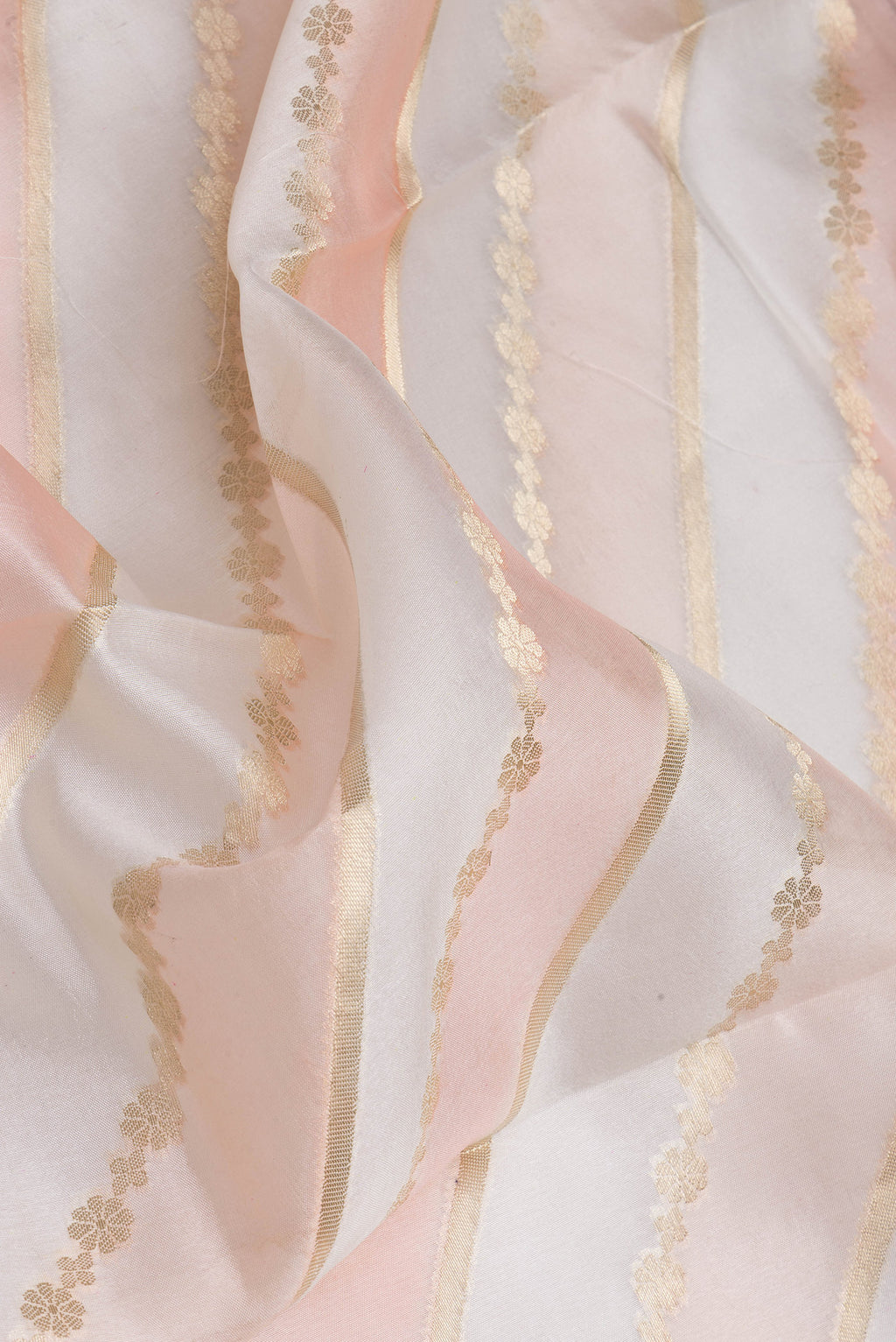 Close up of Cream Tussar Silk Saree with Zari Brocade on the body and Zari Border.  displaying folds