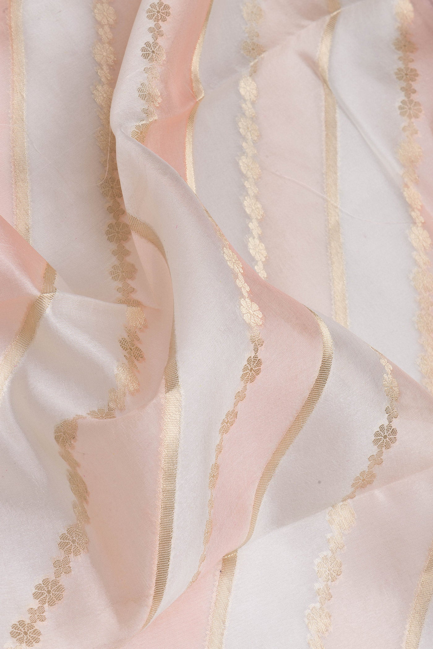 Close up of Cream Tussar Silk Saree with Zari Brocade on the body and Zari Border.  displaying folds