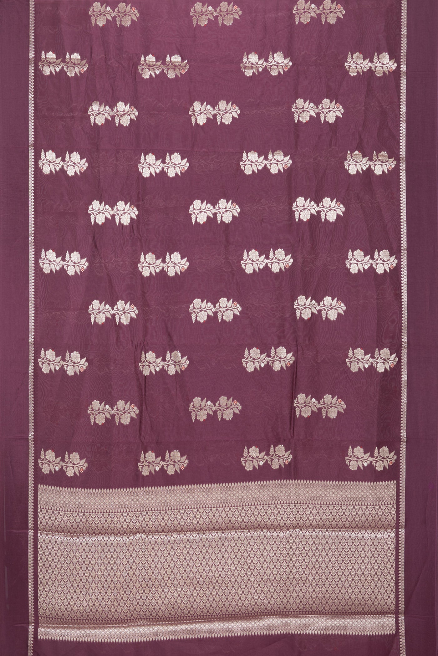 Flat view of Burgundy Blended Tussar Silk Saree with Zari Butta on the body and Zari Border. 