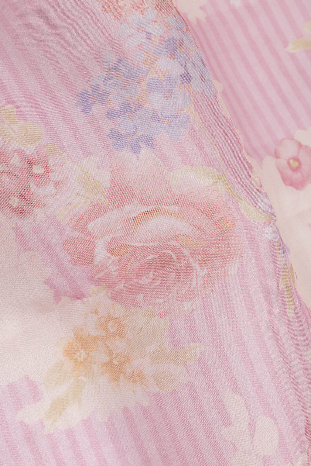 Close up of Rose pink Organza Silk Saree with Floral Print on the body and Zari Border.  displaying folds