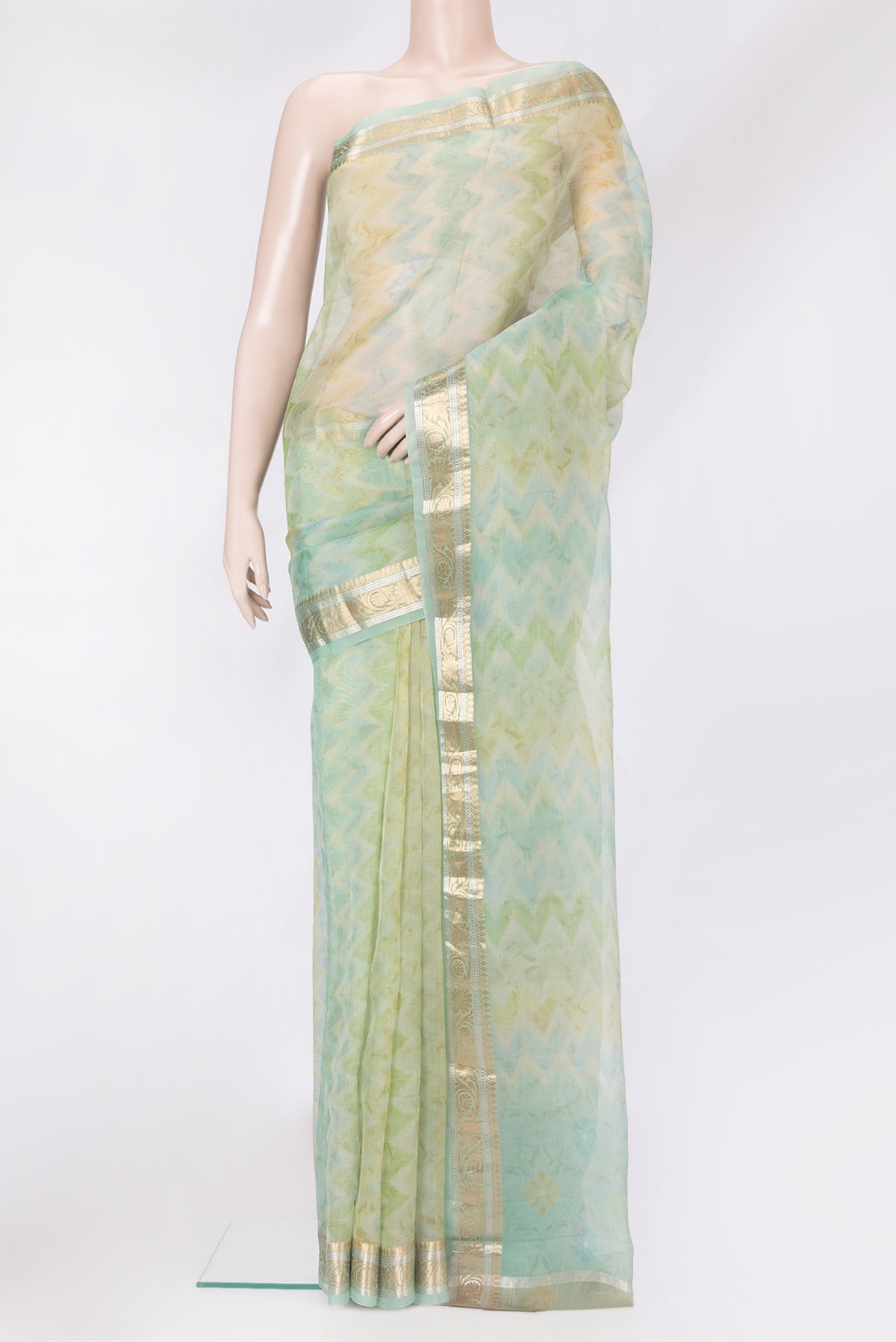 Pista Green Organza Silk Saree with Printed design on the body and Zari Border.  displayed on a mannequin