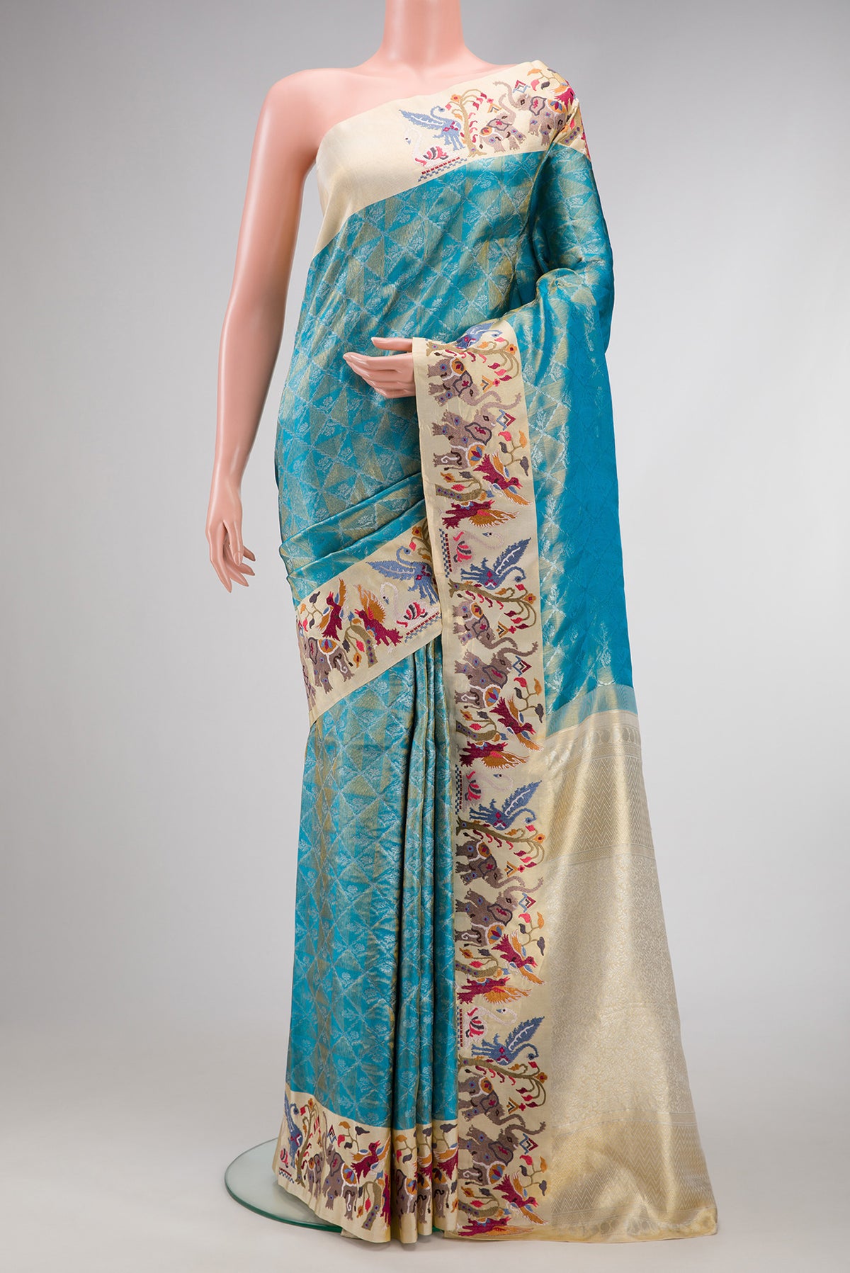 Pure Silk Pure Zari Sky Blue Dual Tone Banarasi Saree with Zari Brocade on the body and Embroidery Border.  displayed on a mannequin