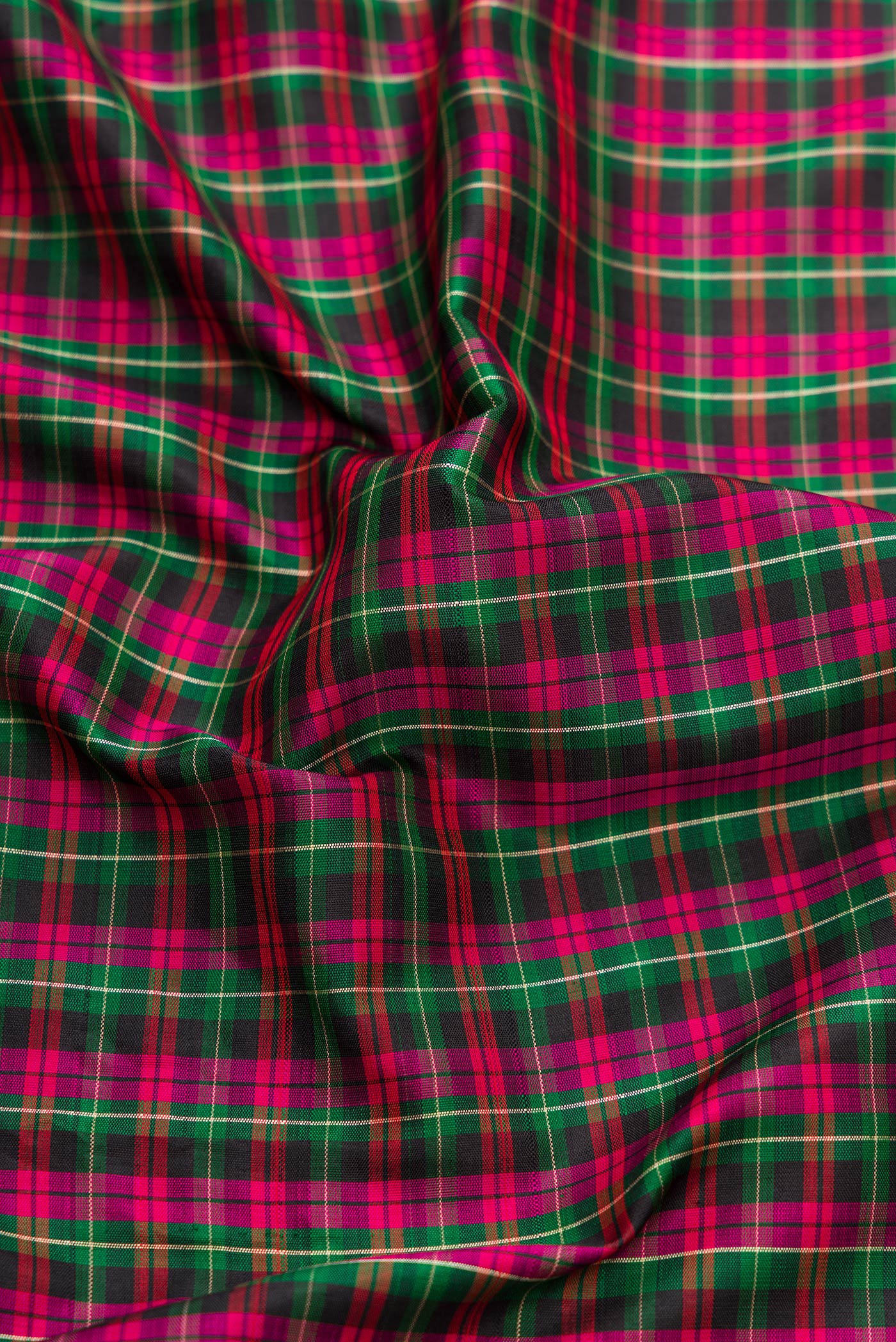 Close up of Pure Silk Pure Zari Green, Pink and Black Color Banarasi Saree with Checked design on the body and Embroidery Border.  displaying folds