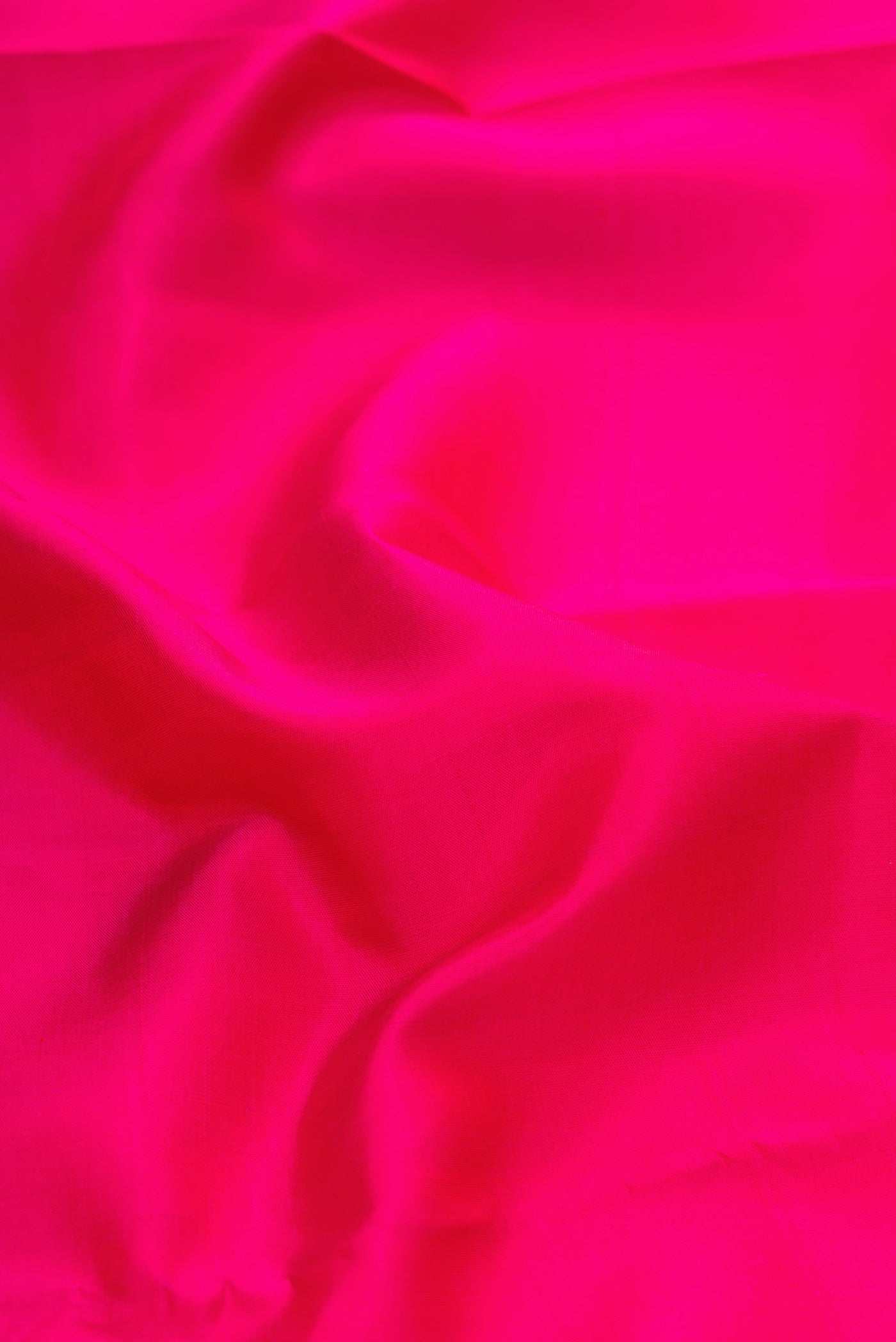 Close up of Pink Kanjivaram Silk Saree with Plain Body and Zari Border.  displaying folds