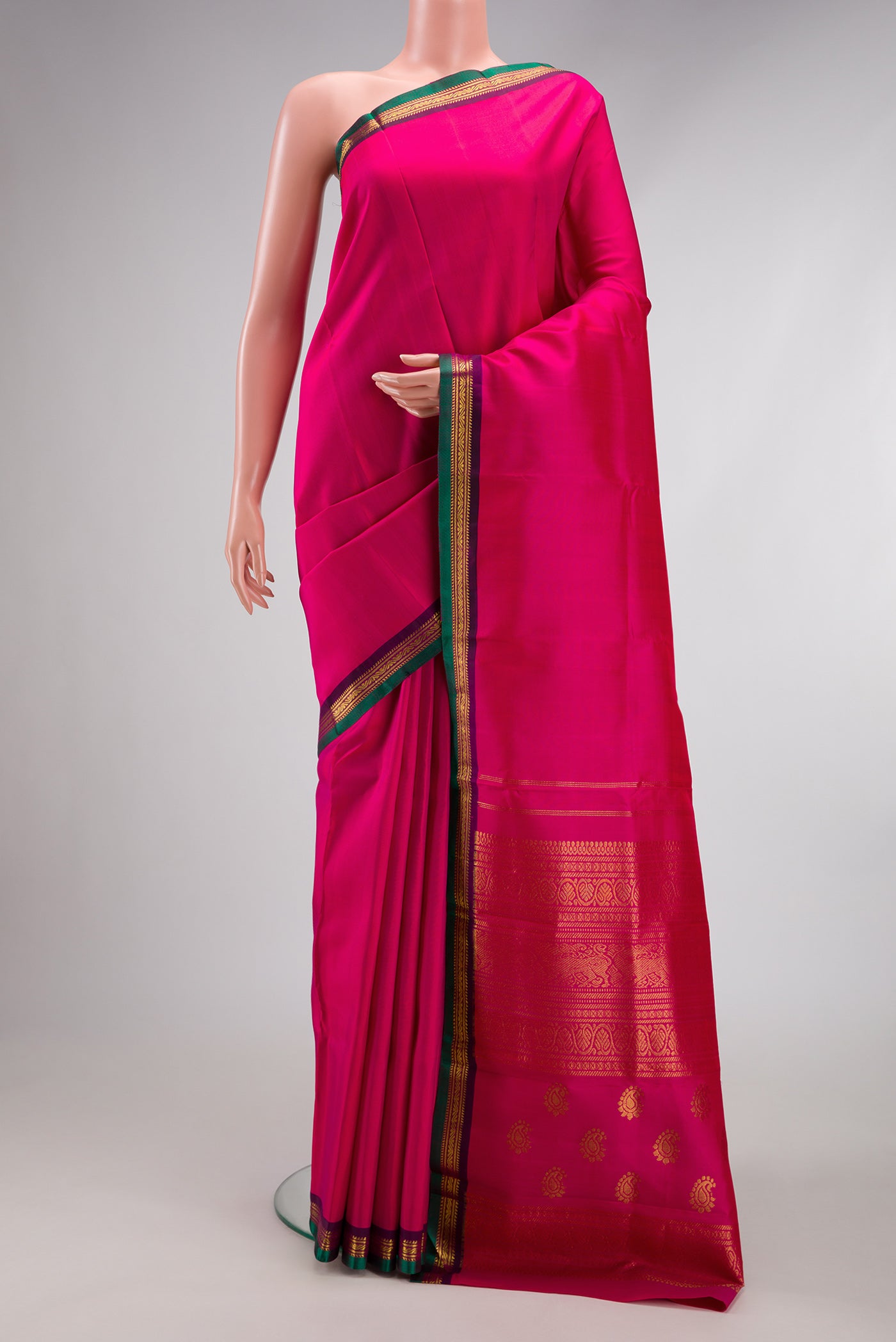 Pink Kanjivaram Silk Saree with Plain Body and Zari Border.  displayed on a mannequin