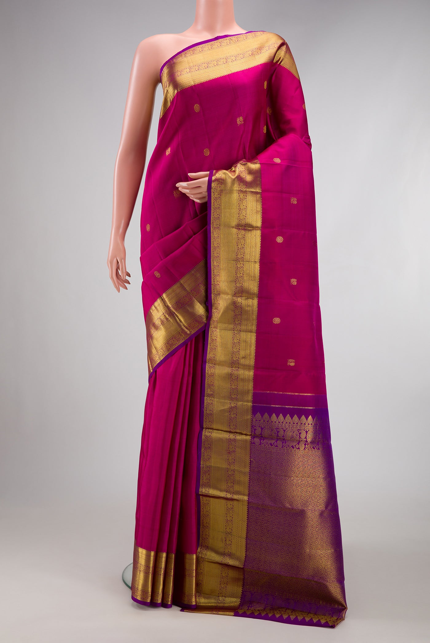 Pink Kanjivaram Silk Saree with Zari Butta on the body and Zari Border.  displayed on a mannequin