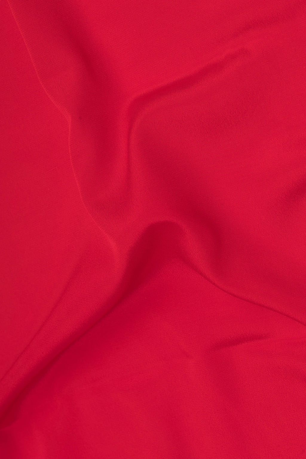 Close up of Red Mysore Silk Saree with Plain Body and Zari Border.  displaying folds