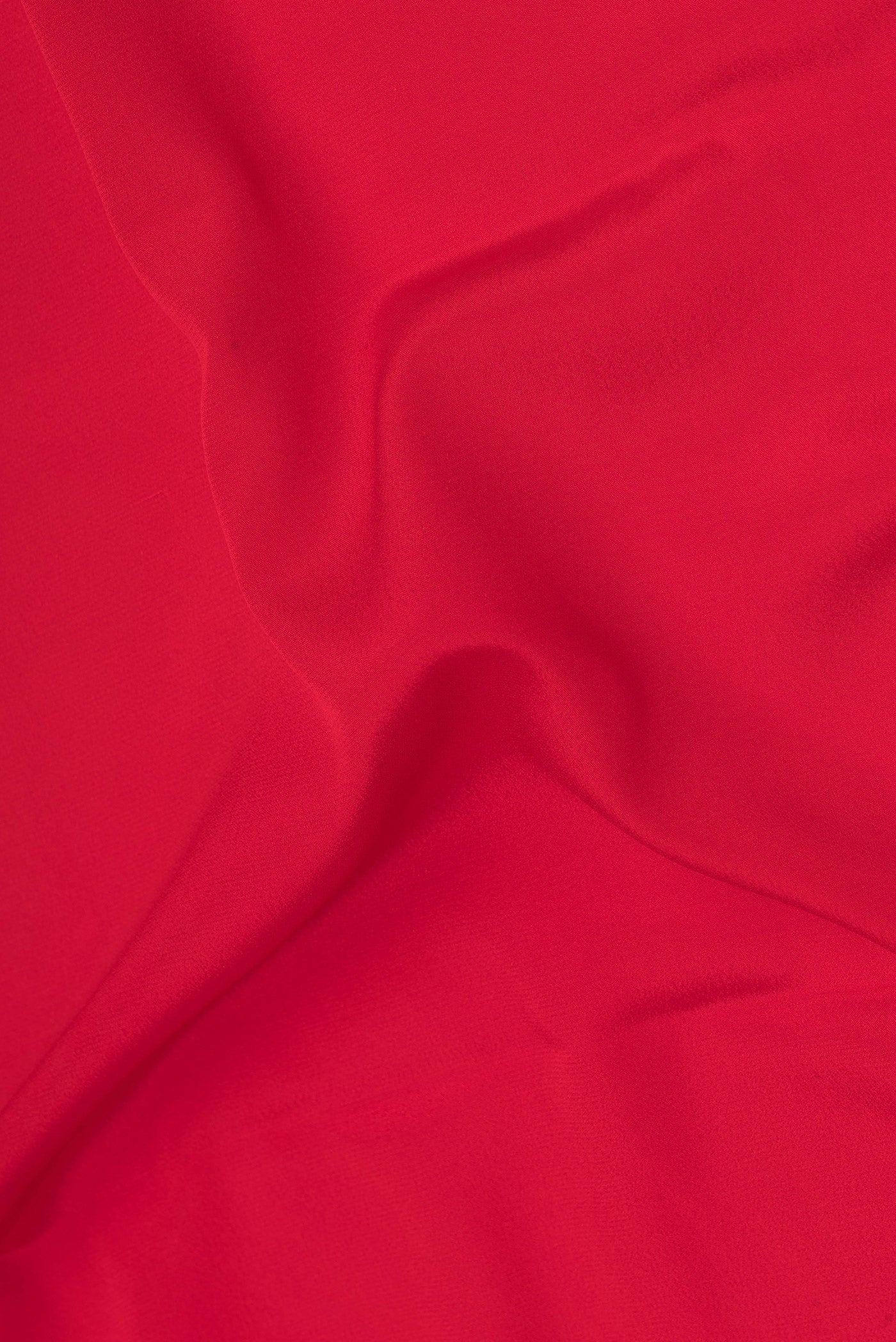 Close up of Red Mysore Silk Saree with Plain Body and Zari Border.  displaying folds