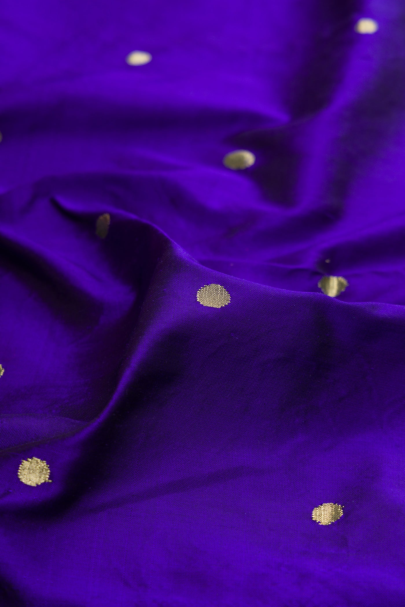 Close up of Royal Blue Paithani Silk Saree with Zari Butta on the body and Paithani Border.  displaying folds