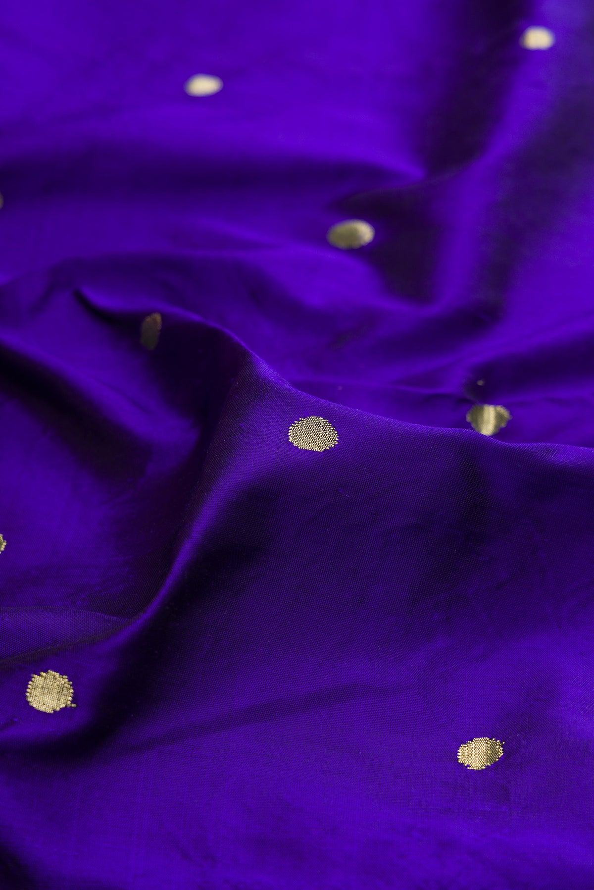 Close up of Royal Blue Paithani Silk Saree with Zari Butta on the body and Paithani Border.  displaying folds