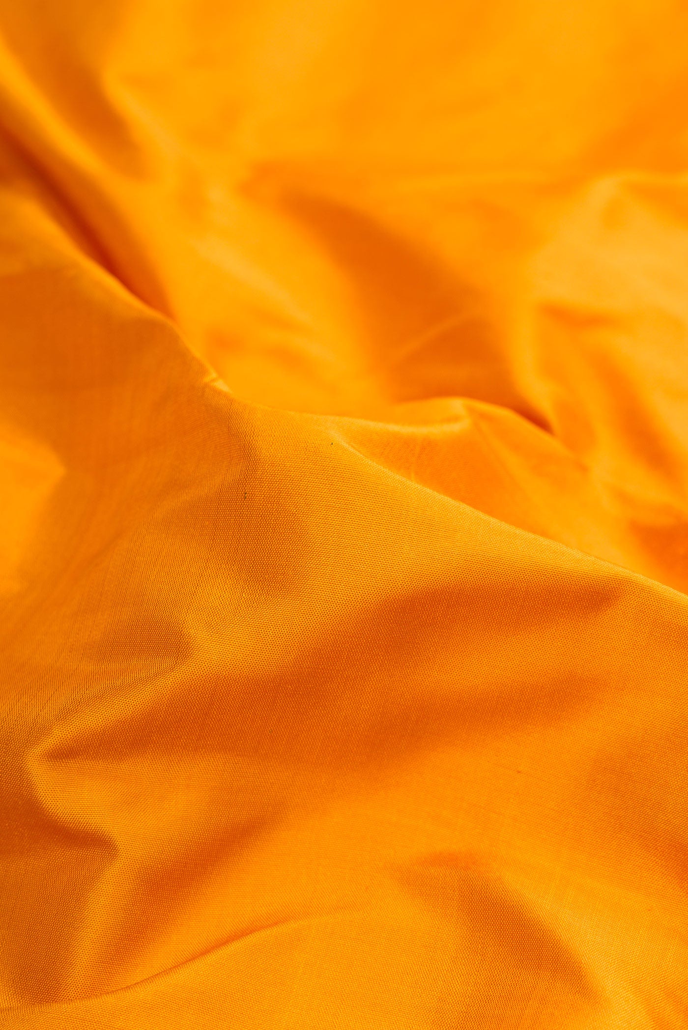 Close up of Pure Silk Pure Zari Mustard Dual Tone Kanchipuram Nine Yards Saree with Plain Body and Zari Border.  displaying folds