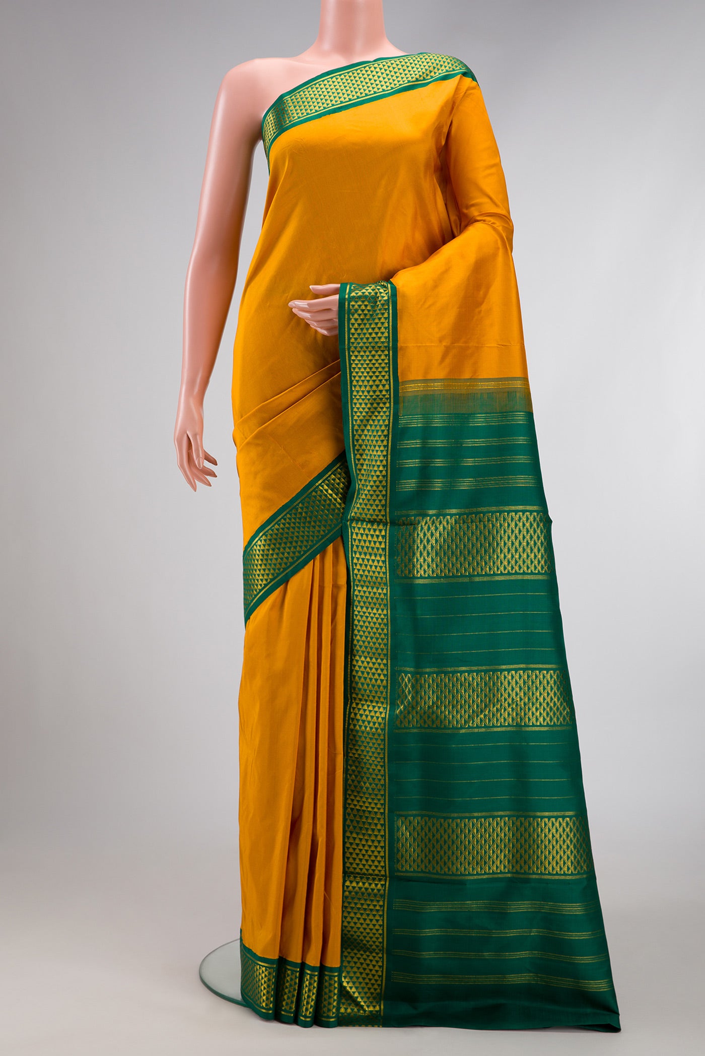 Pure Silk Pure Zari Mustard Dual Tone Kanchipuram Nine Yards Saree with Plain Body and Zari Border.  displayed on a mannequin