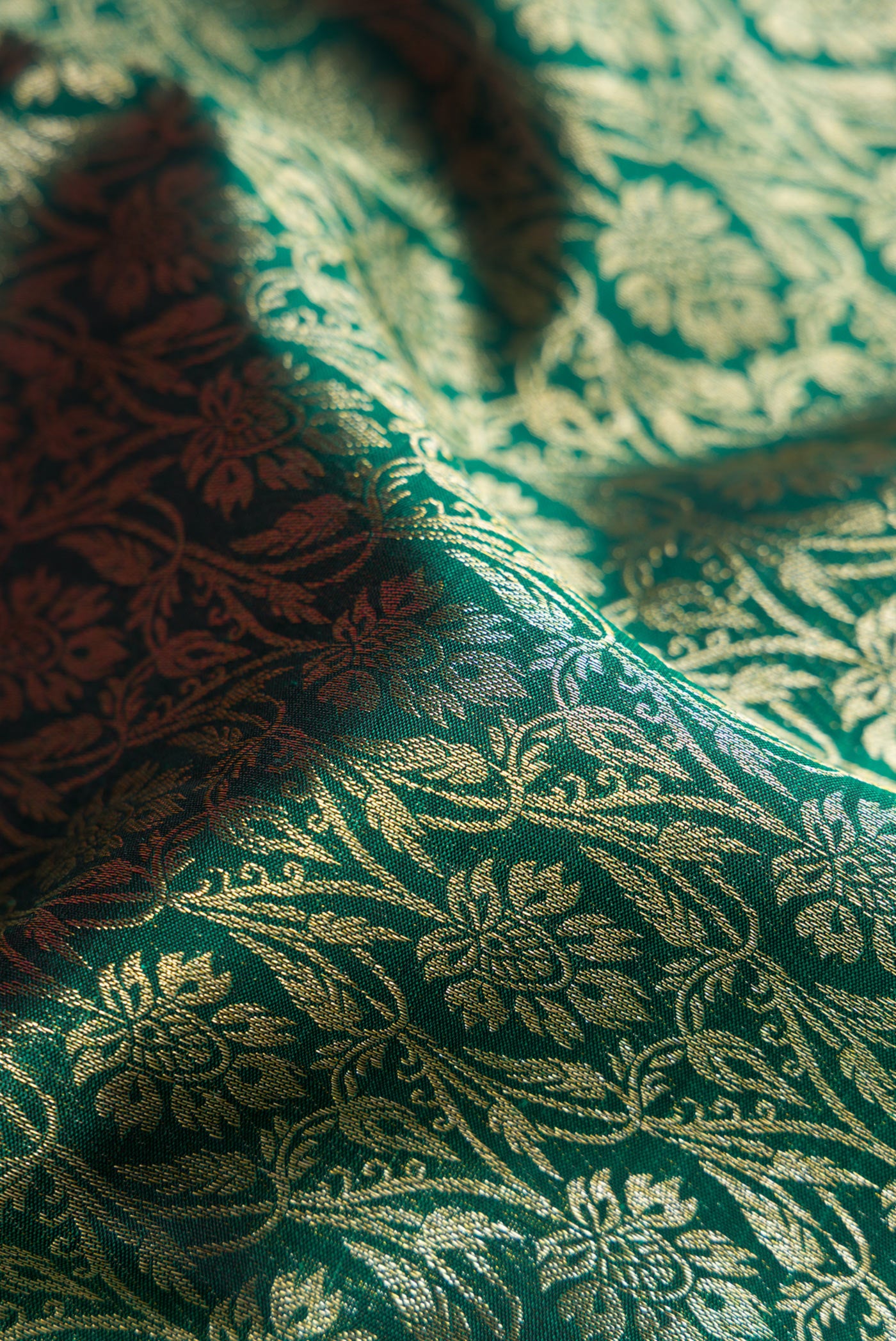 Close up of Bottle Green Dual Tone Kanchipuram Silk Saree with Zari Brocade on the body and Fancy Border.  displaying folds