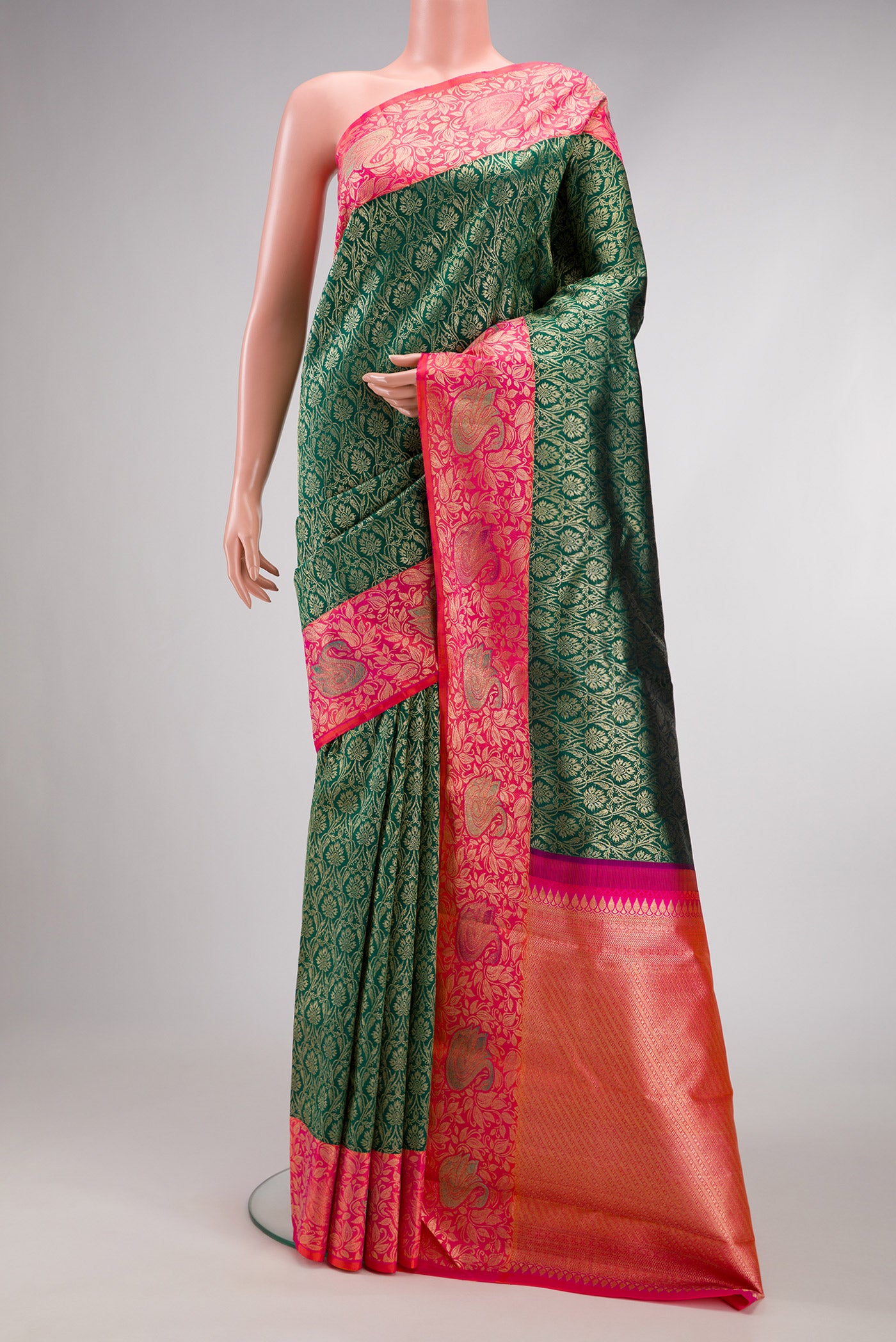 Bottle Green Dual Tone Kanchipuram Silk Saree with Zari Brocade on the body and Fancy Border.  displayed on a mannequin