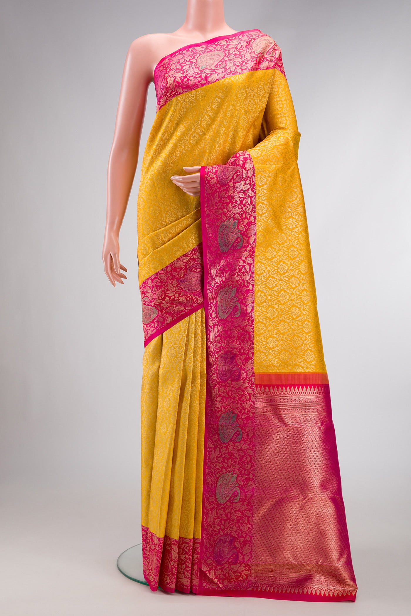 Mustard Dual Tone Kanchipuram Silk Saree with Zari Brocade on the body and Zari Border.  displayed on a mannequin
