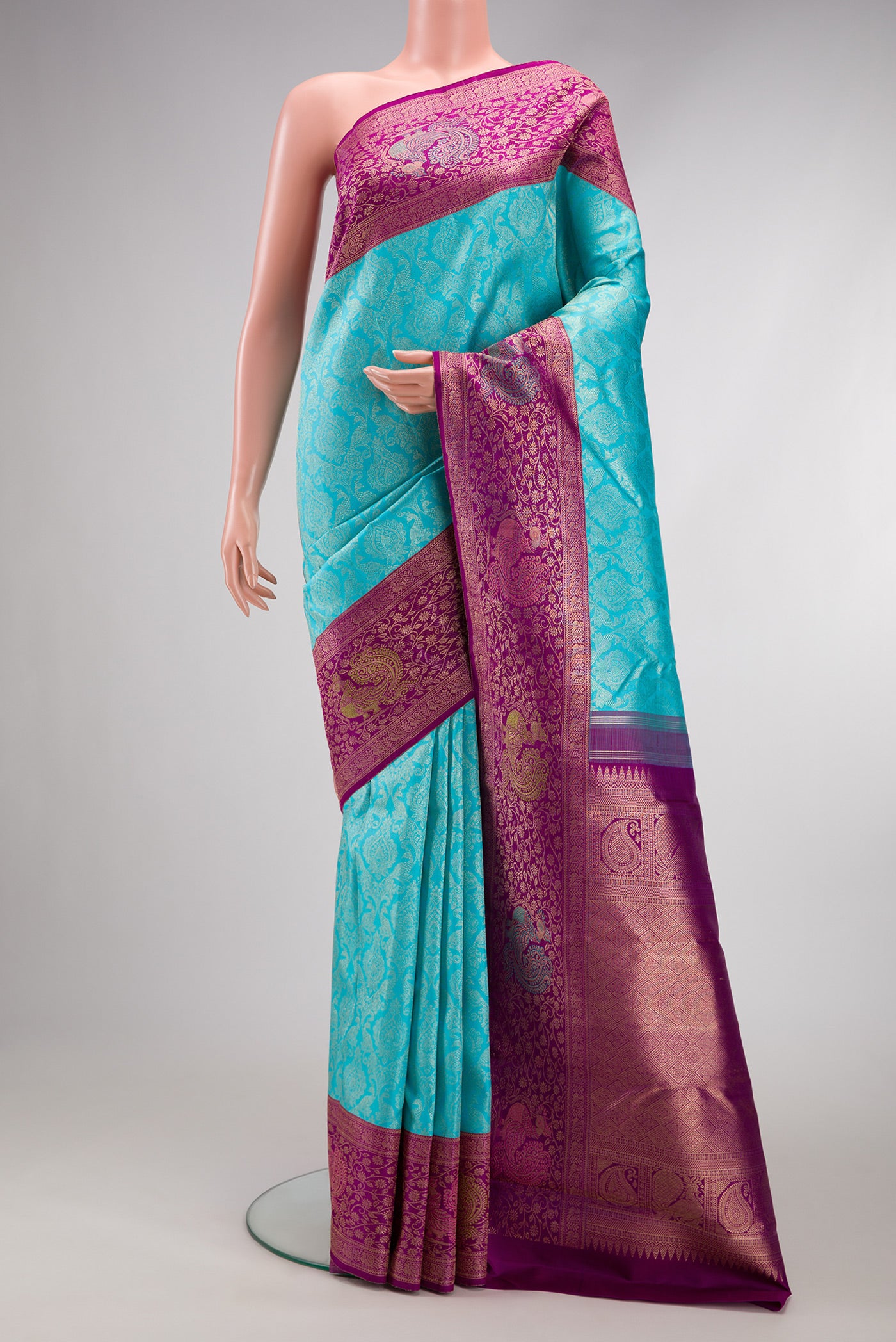Sky Blue Dual Tone Kanchipuram Silk Saree with Zari Brocade on the body and Fancy Border.  displayed on a mannequin