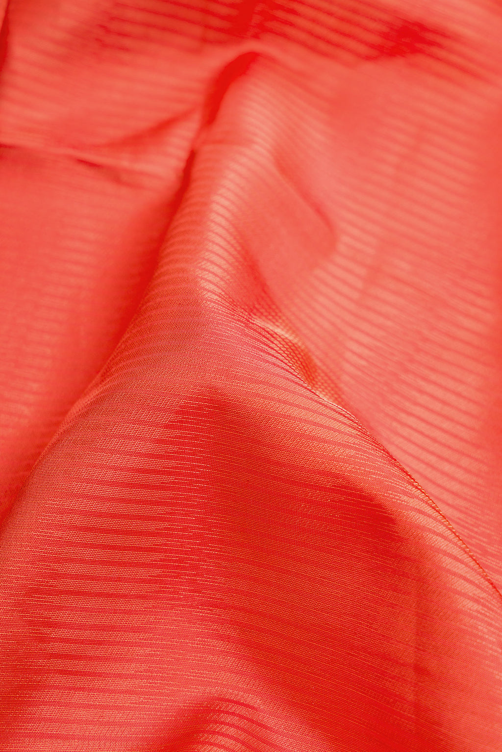 Close up of Golden Peach Dual Tone Soft Silk Saree with Zari Brocade on the body and Zari Border.  displaying folds