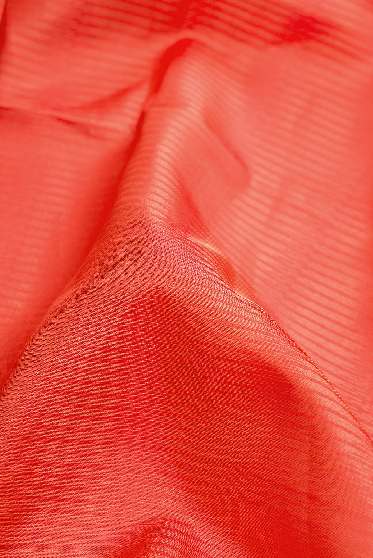 Close up of Golden Peach Dual Tone Soft Silk Saree with Zari Brocade on the body and Zari Border.  displaying folds