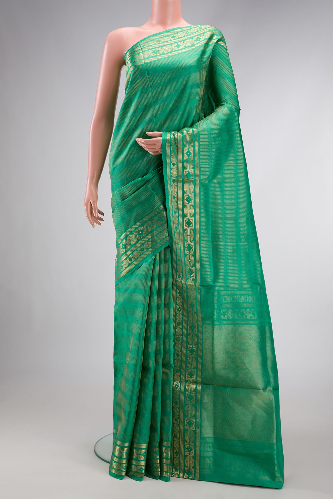 Green Dual Tone Soft Silk Saree with Zari Butta on the body and Zari Border.  displayed on a mannequin