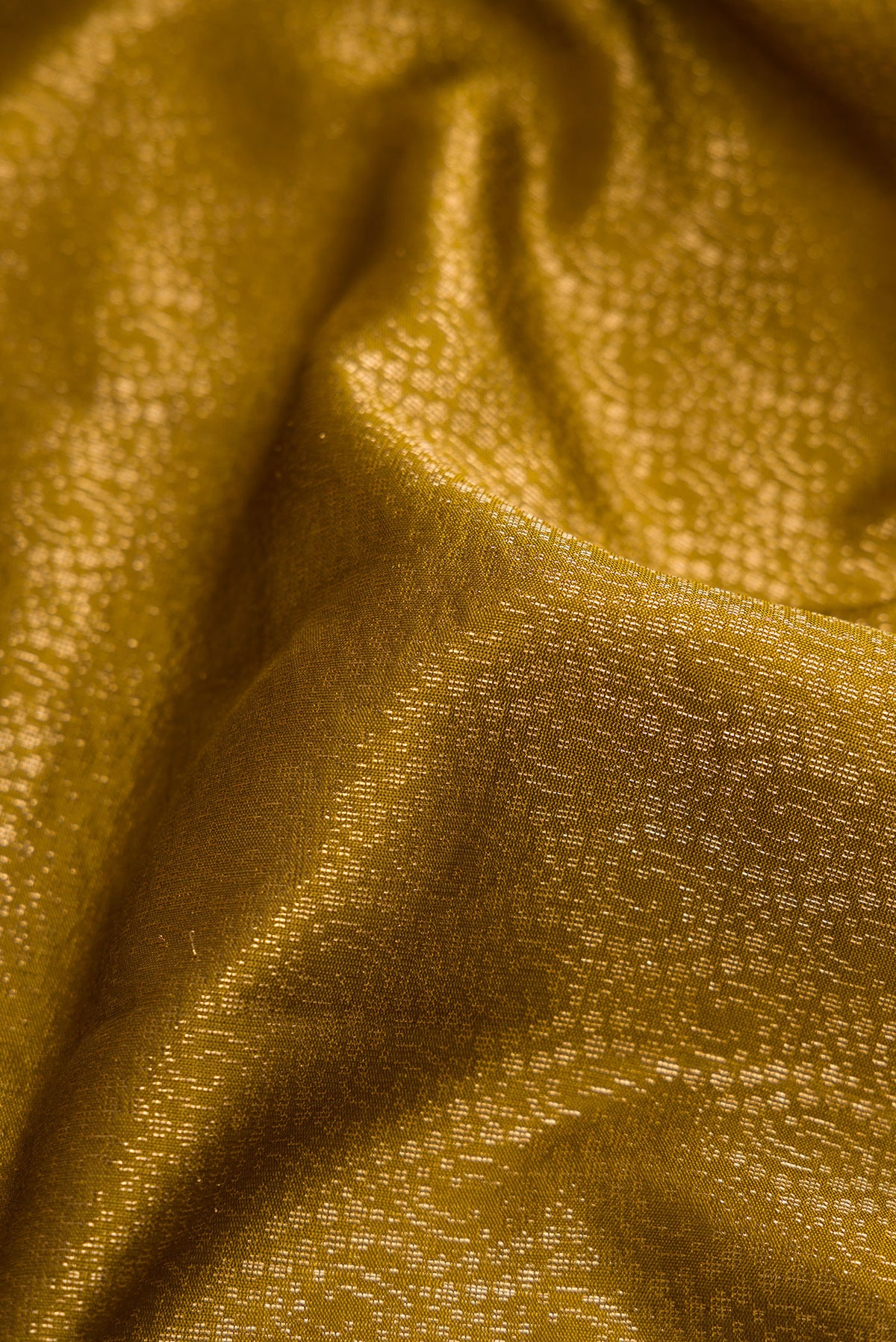 Close up of Mehandi Green Dual Tone Soft Silk Saree with Zari Brocade on the body and Zari Border.  displaying folds