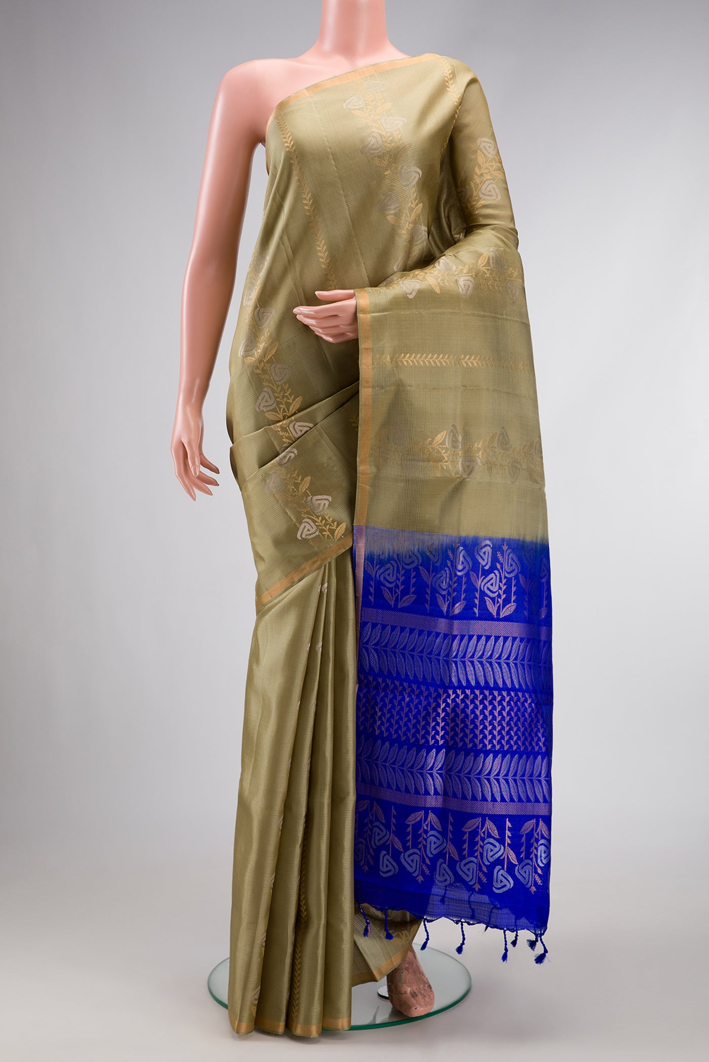Pista Green Dual Tone Soft Silk Saree with Zari Butta on the body and Zari Border.  displayed on a mannequin