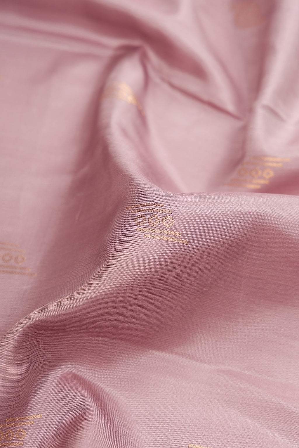 Close up of Brown Dual Tone Soft Silk Saree with Zari Butta on the body and Zari Border.  displaying folds