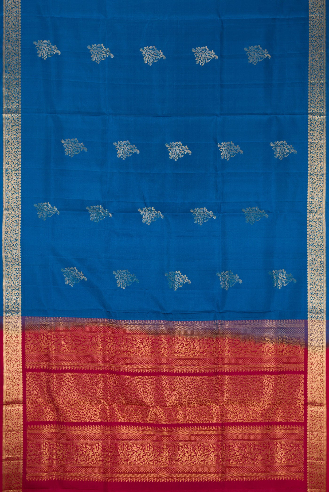 Flat view of Peacock Blue Dual Tone Soft Silk Saree with Zari Butta on the body and Zari Border. 