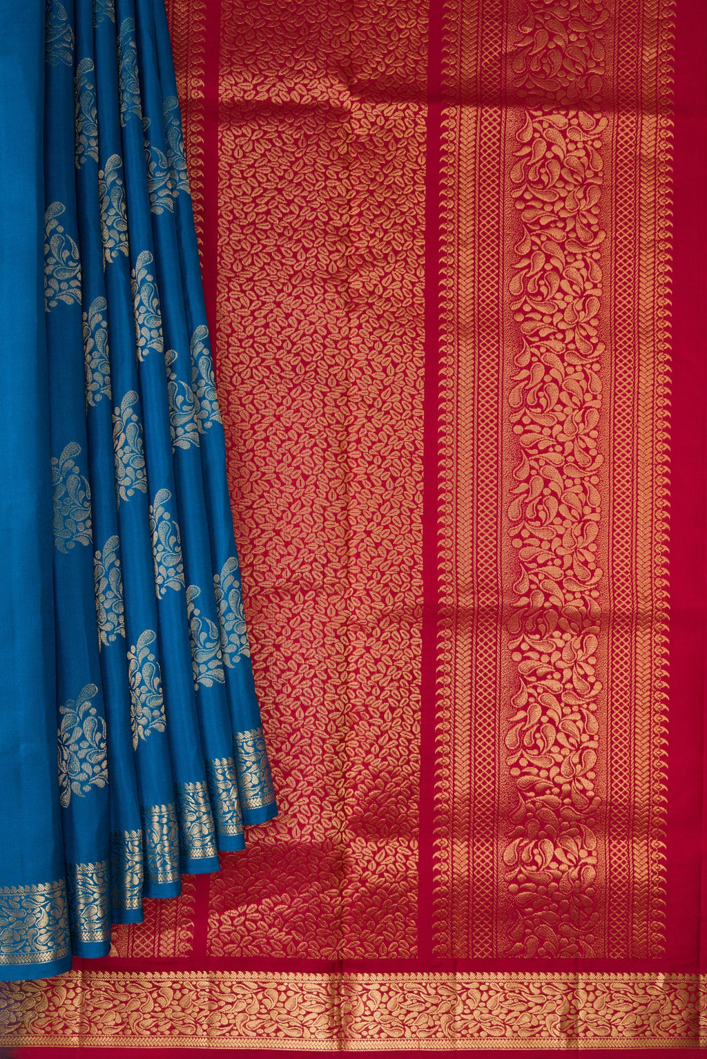 Pleats and pallu of Peacock Blue Dual Tone Soft Silk Saree with Zari Butta on the body and Zari Border. 