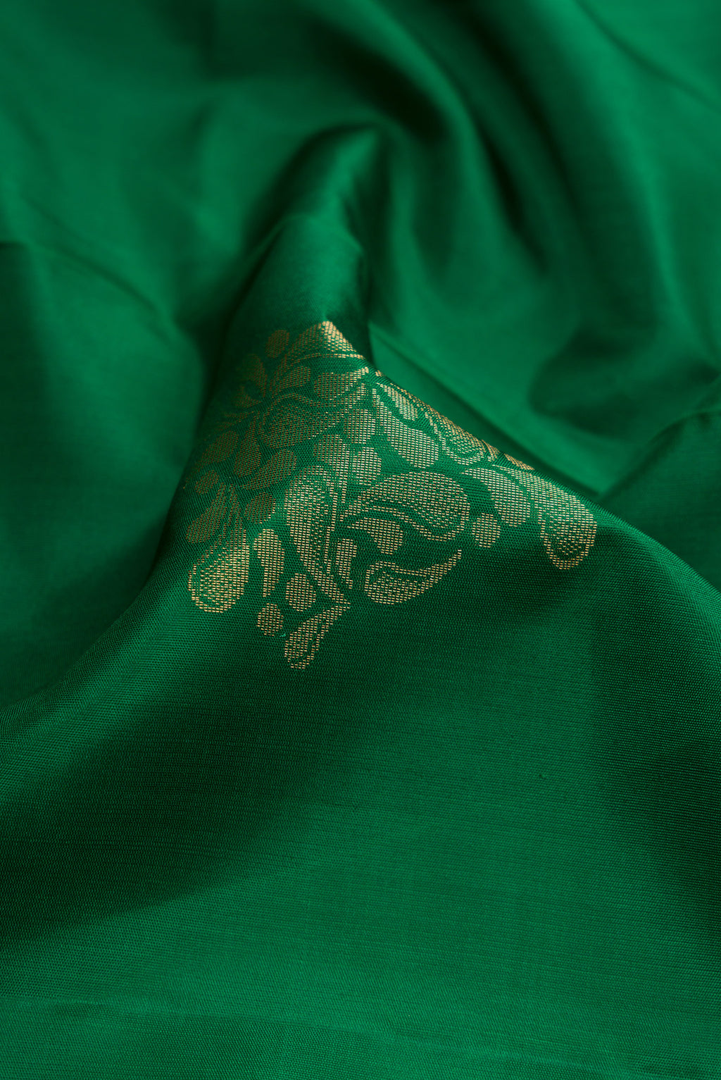 Close up of Bottle Green Dual Tone Soft Silk Saree with Zari Butta on the body and Zari Border.  displaying folds