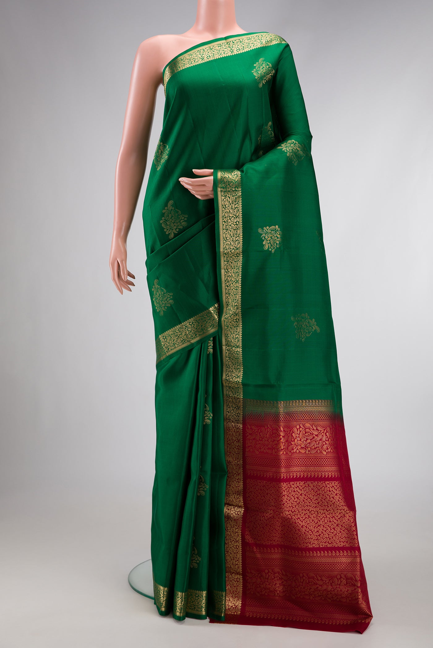 Bottle Green Dual Tone Soft Silk Saree with Zari Butta on the body and Zari Border.  displayed on a mannequin