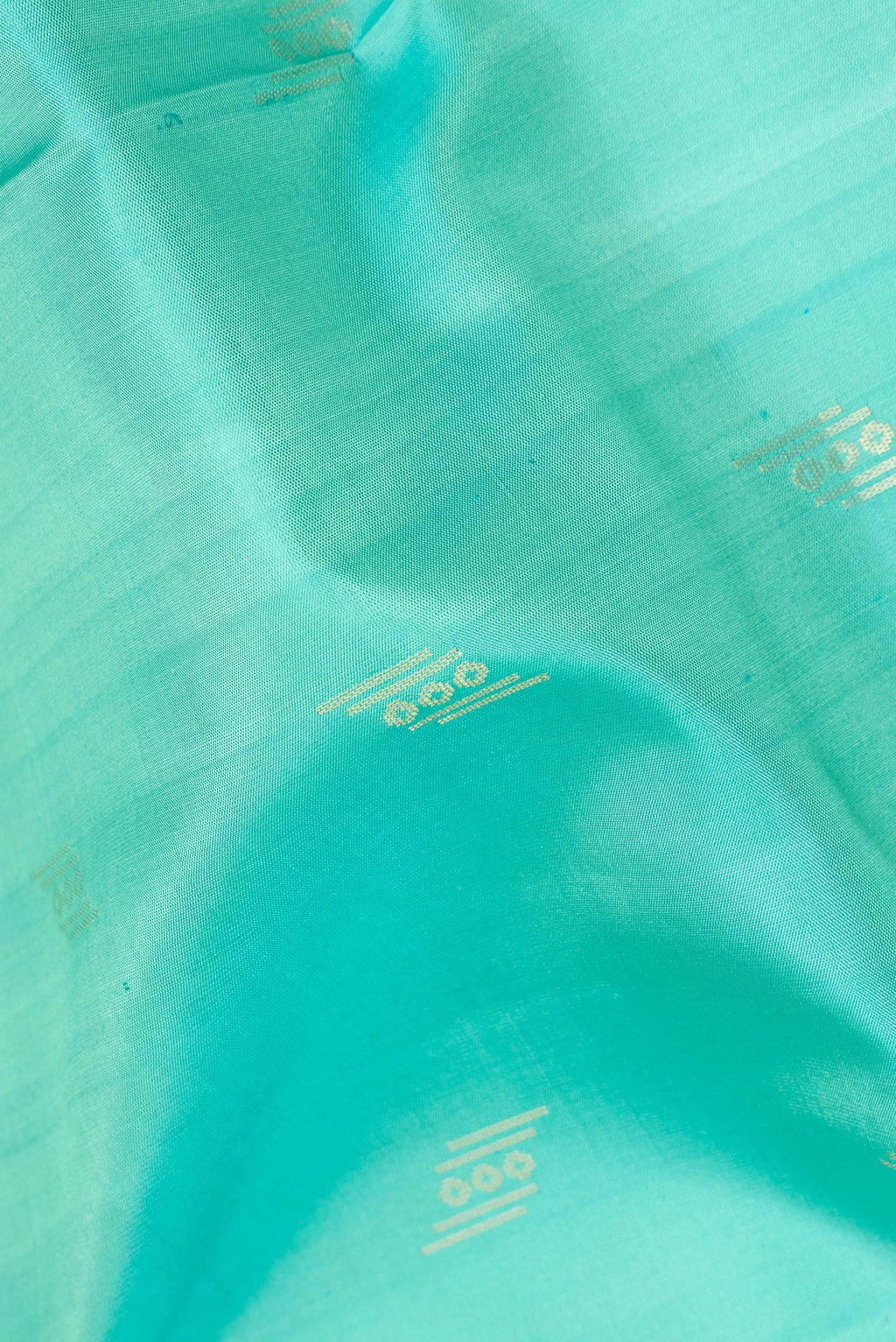 Close up of Pure Silk Sea Green Soft Saree with Zari Butta on the body and Zari Border.  displaying folds