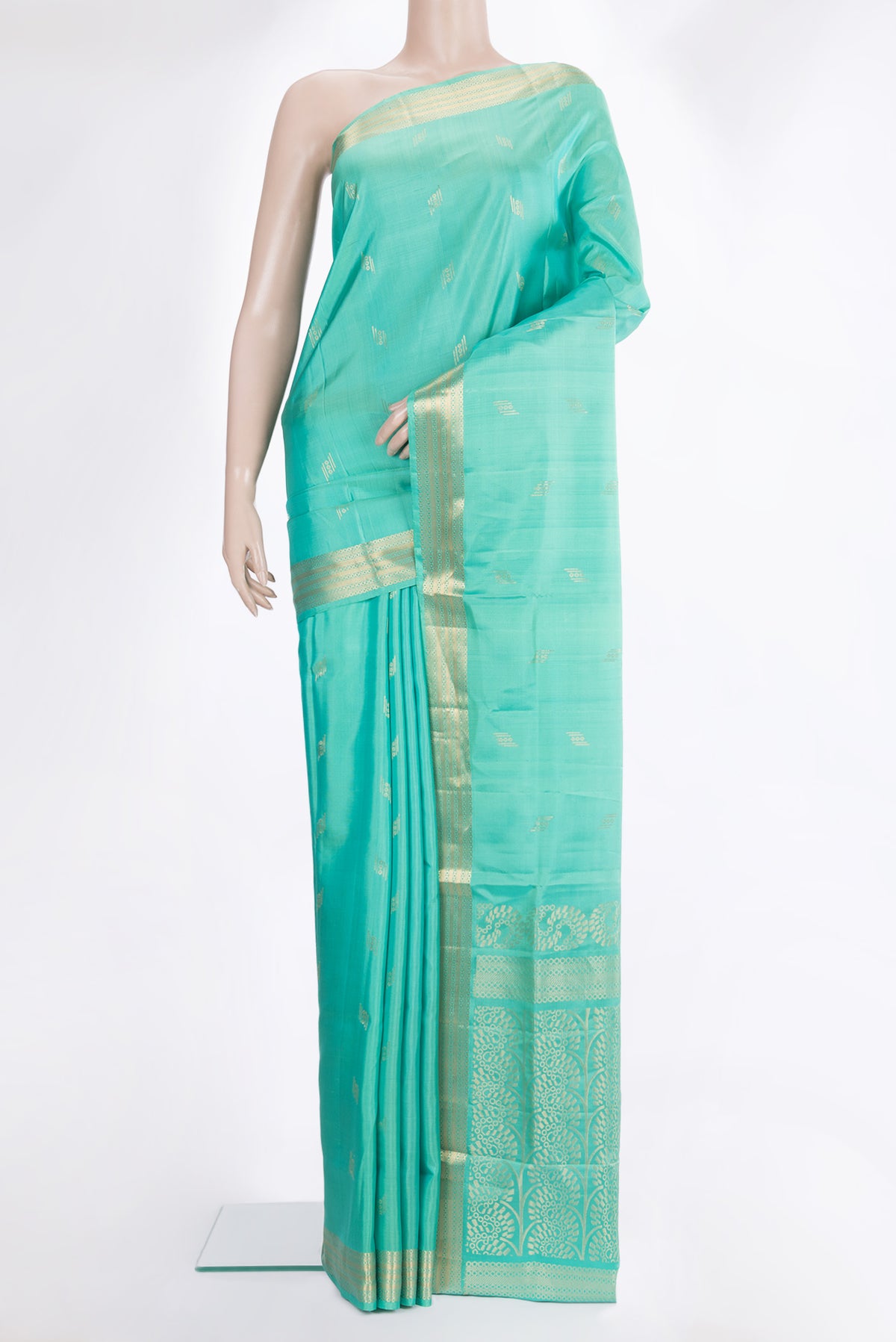 Pure Silk Sea Green Soft Saree with Zari Butta on the body and Zari Border.  displayed on a mannequin