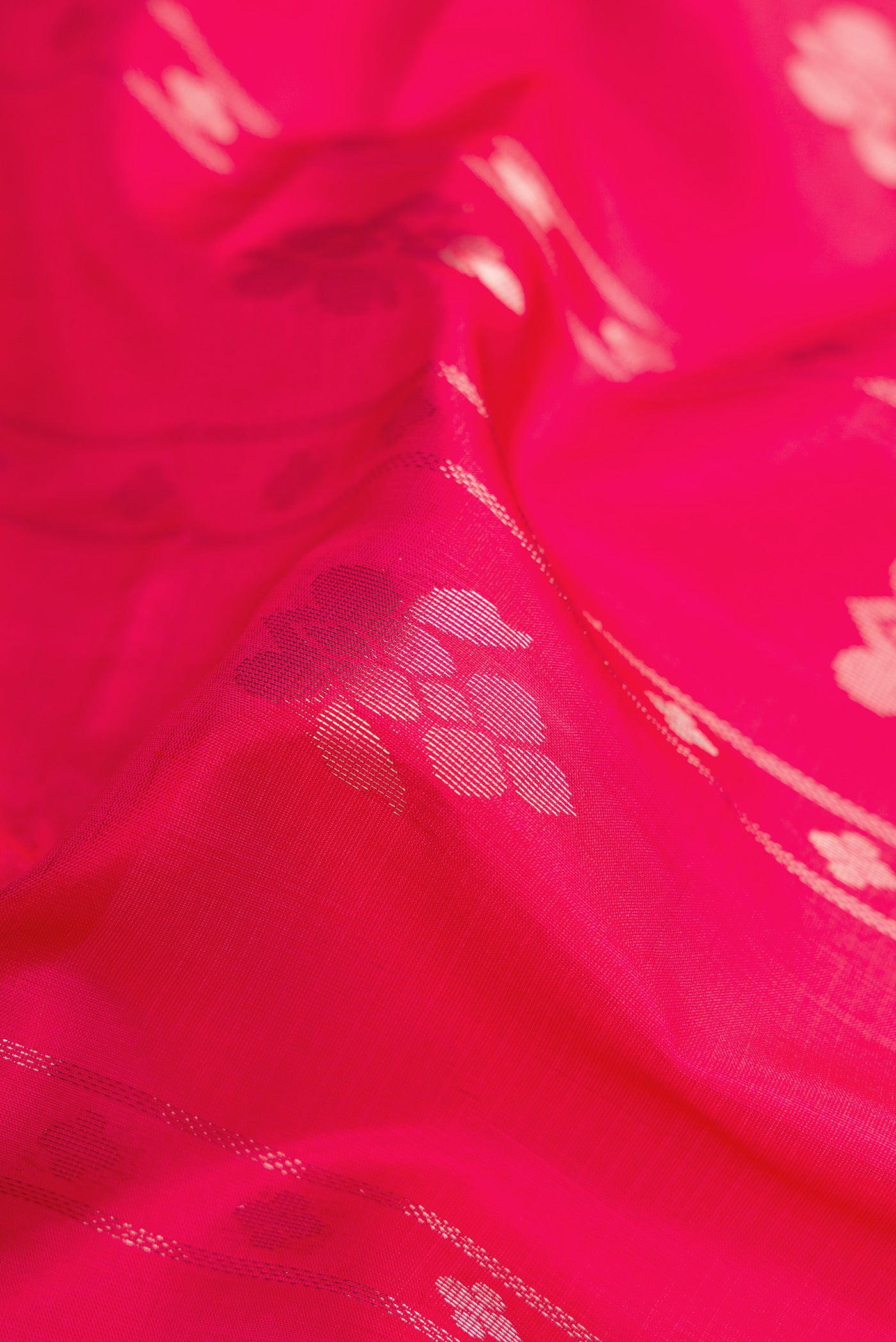 Close up of Pink Soft Silk Saree with Zari Butta on the body and Zari Border.  displaying folds