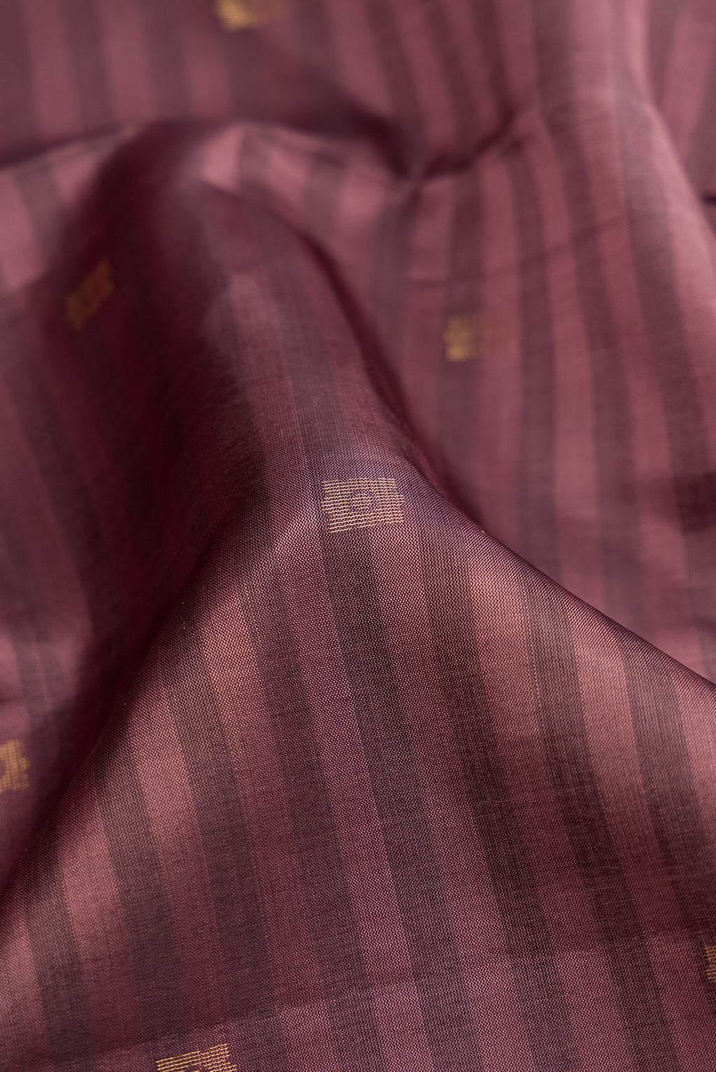 Close up of Brown Dual Tone Soft Silk Saree with Stripes on the body and Fancy Border.  displaying folds