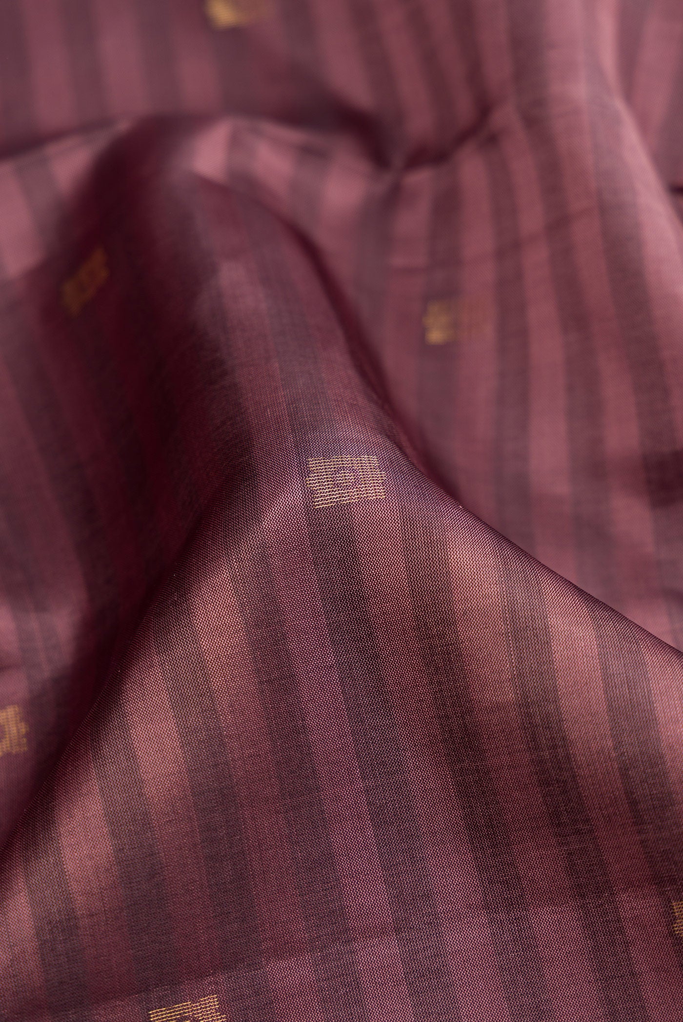 Close up of Brown Dual Tone Soft Silk Saree with Stripes on the body and Fancy Border.  displaying folds