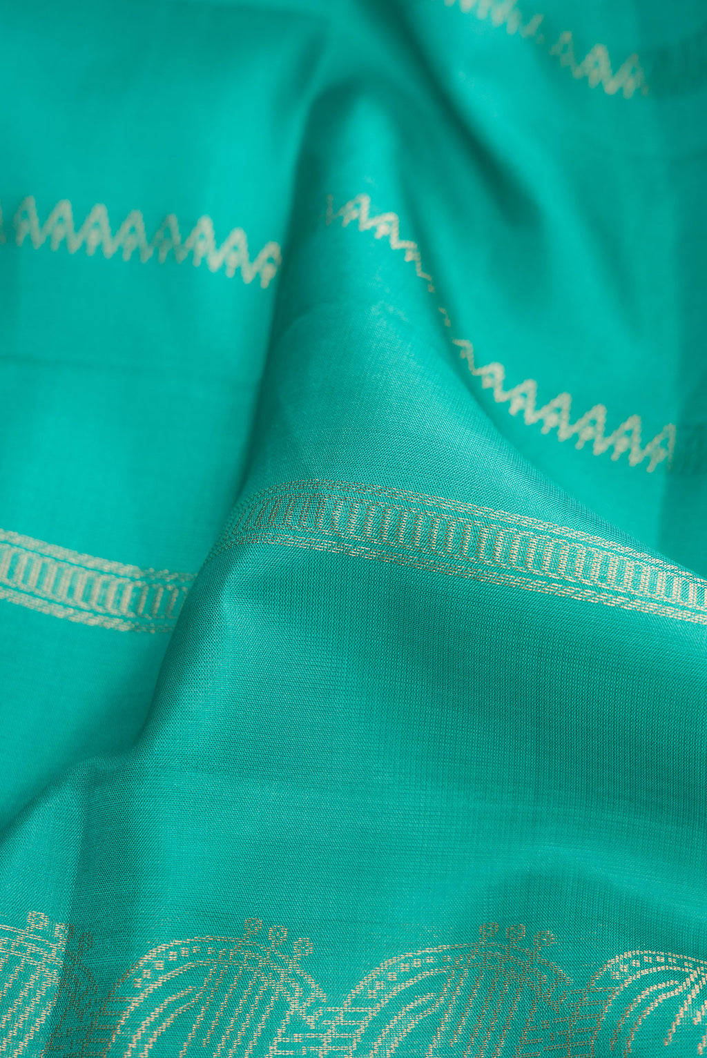 Close up of Sea Green Dual Tone Soft Silk Saree with Stripes on the body and Without Border.  displaying folds