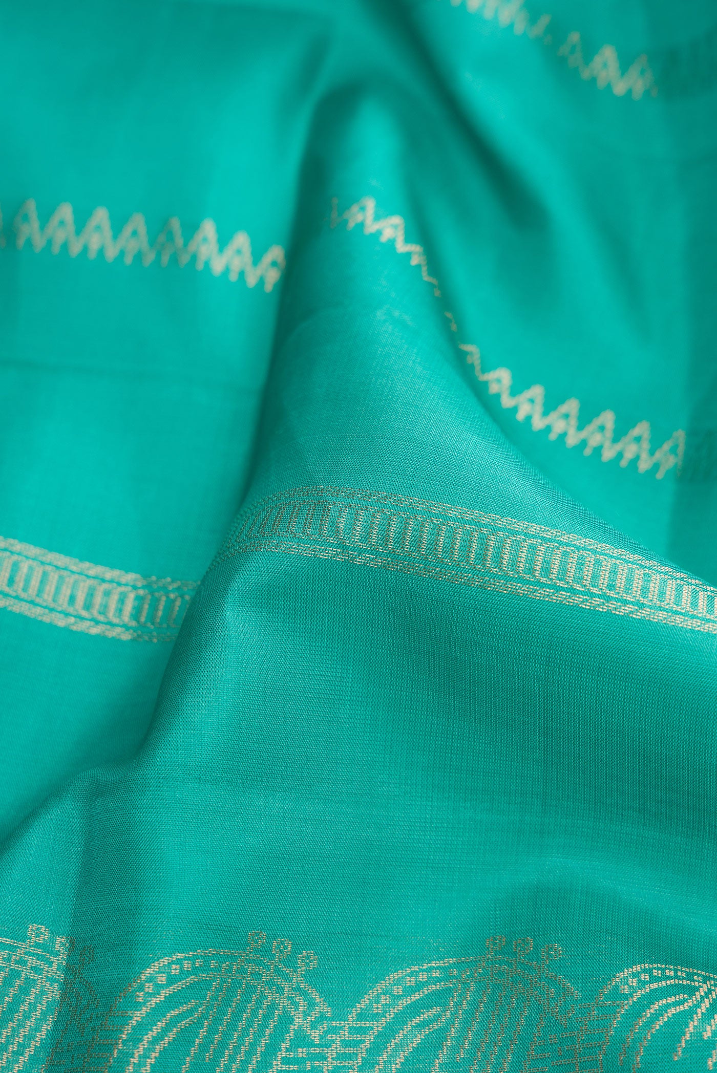 Close up of Sea Green Dual Tone Soft Silk Saree with Stripes on the body and Without Border.  displaying folds