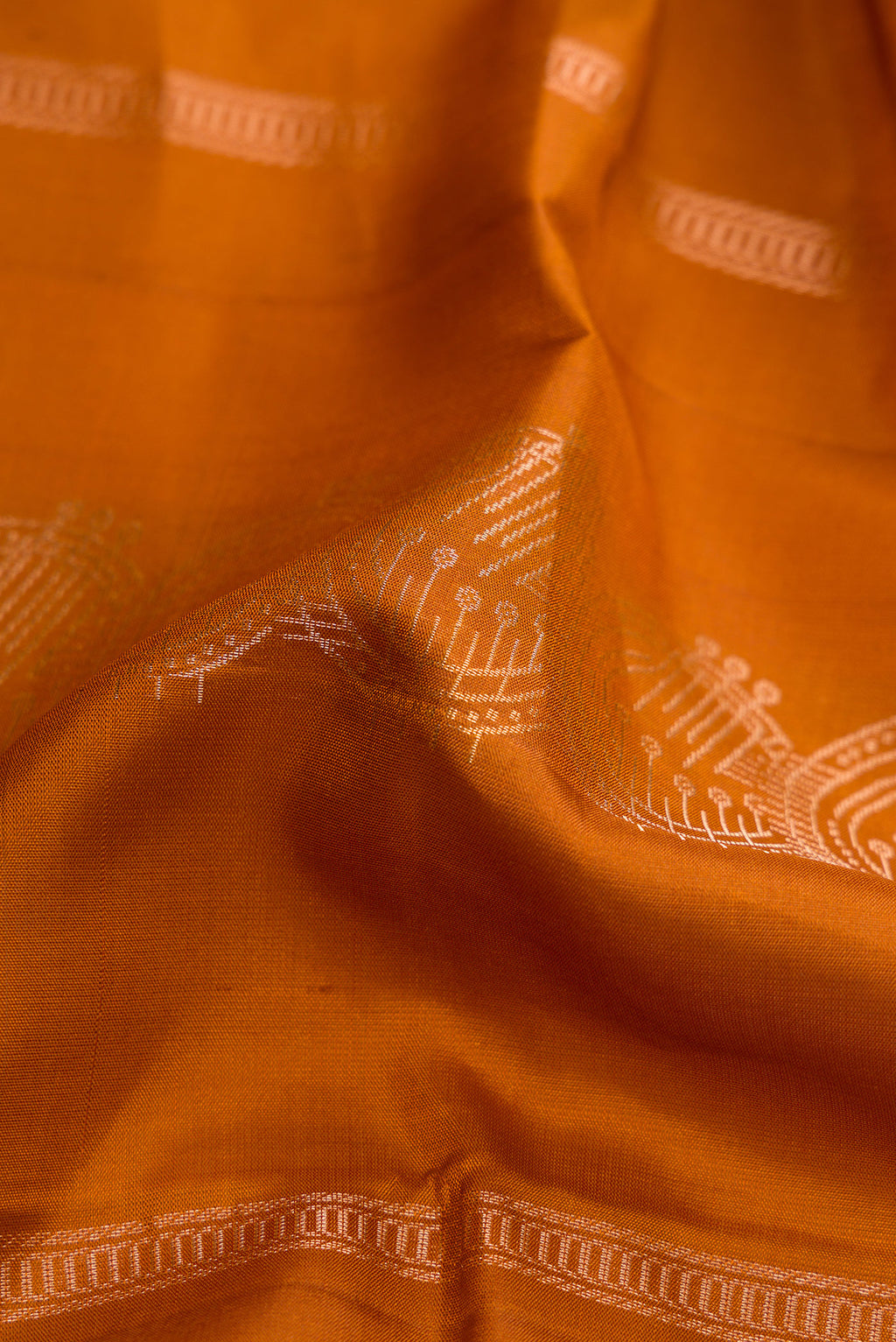 Close up of Mustard Dual Tone Soft Silk Saree with Stripes on the body and Without Border.  displaying folds